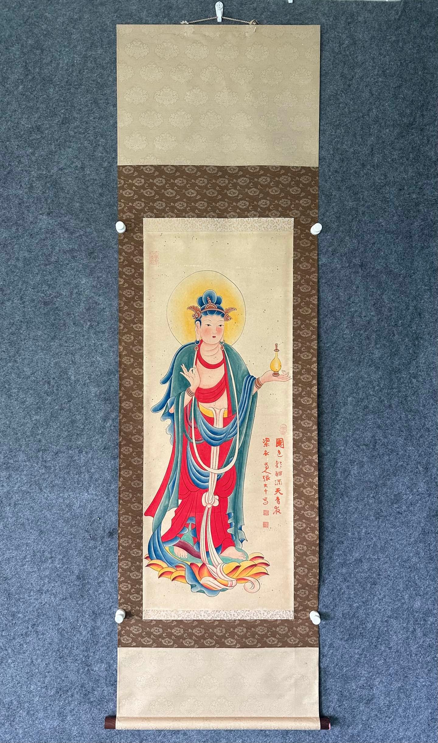 Zhang Daqian, Guanyin on Paper, Hanging Scroll: Zhang Daqian’s Guanyin Painting Hanging Scroll on Paper, length 99cm, width 39cm, color on paper, modern mounting. Using meticulous brushwork and rich colors to depict Guanyin, it features a compass