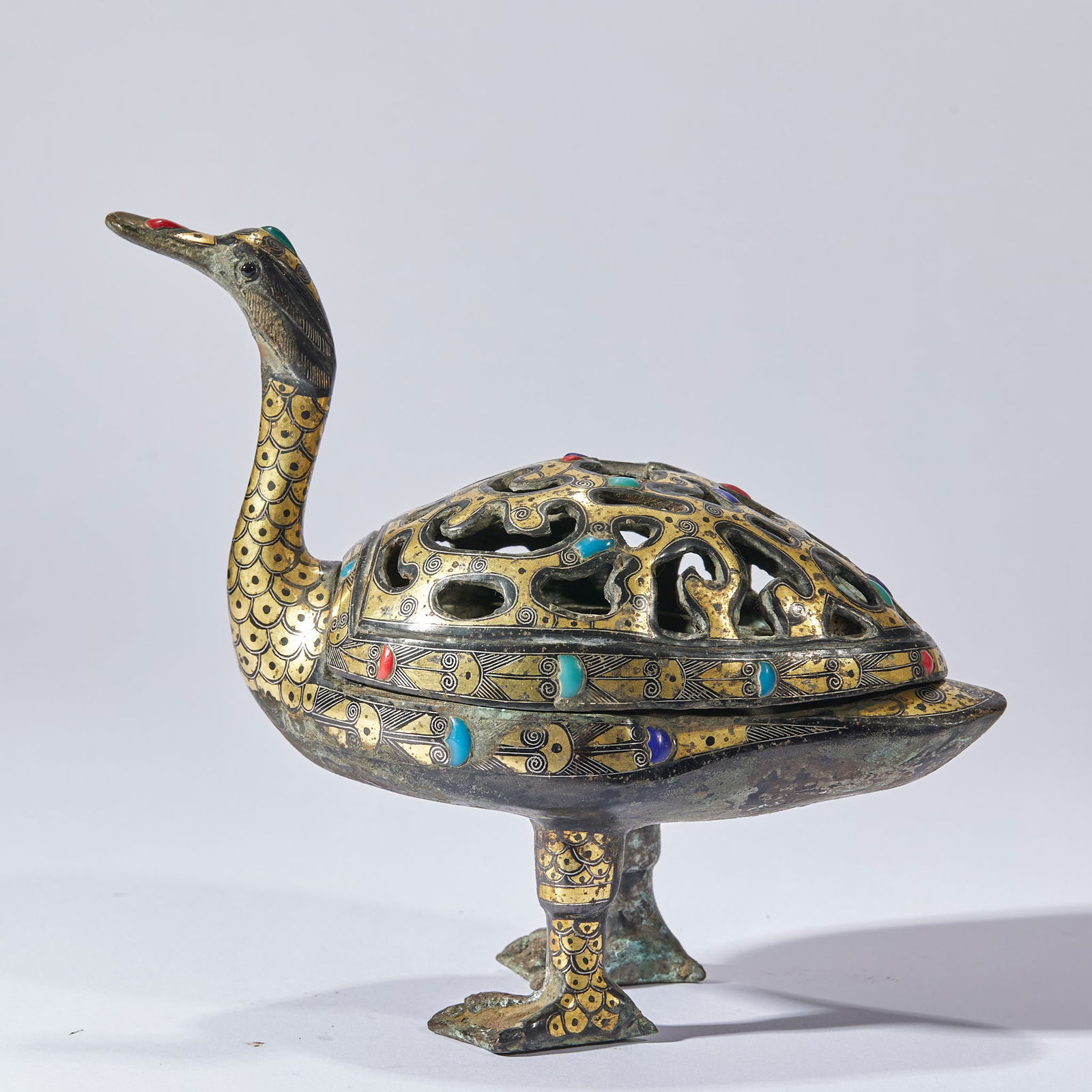 Gold and Silver Inlaid Gemstone-Adorned Duck-Shaped Incense Burner, Pre-Ming Dynasty: Pre-Ming Gold and Silver Inlaid Gemstone Duck-Shaped Incense Burner, height 14.5cm, length 17.5cm, width 8.5cm, weight 856g, bronze with gold and silver inlay, inlaid with turquoise and rubies. The wh