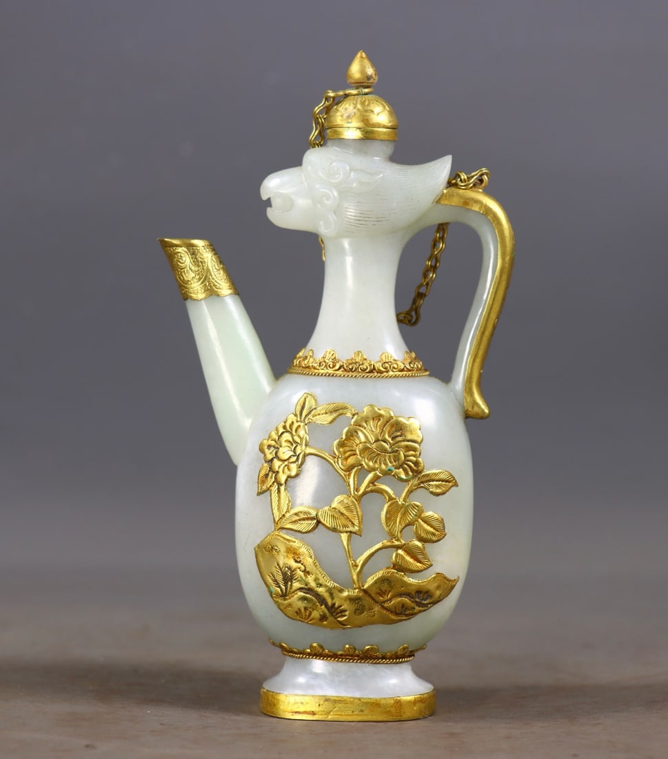 Phoenix-Head Ewer, Hetian Jade with Gold Cladding and Inlay: Hetian Jade Ewer with Gold Wrapping and Phoenix Head Inlay, 16cm in height, 8cm in length, 4cm in width and 267g in weight. Unearthed from an aristocratic tomb of the Tang to Song Dynasty and later