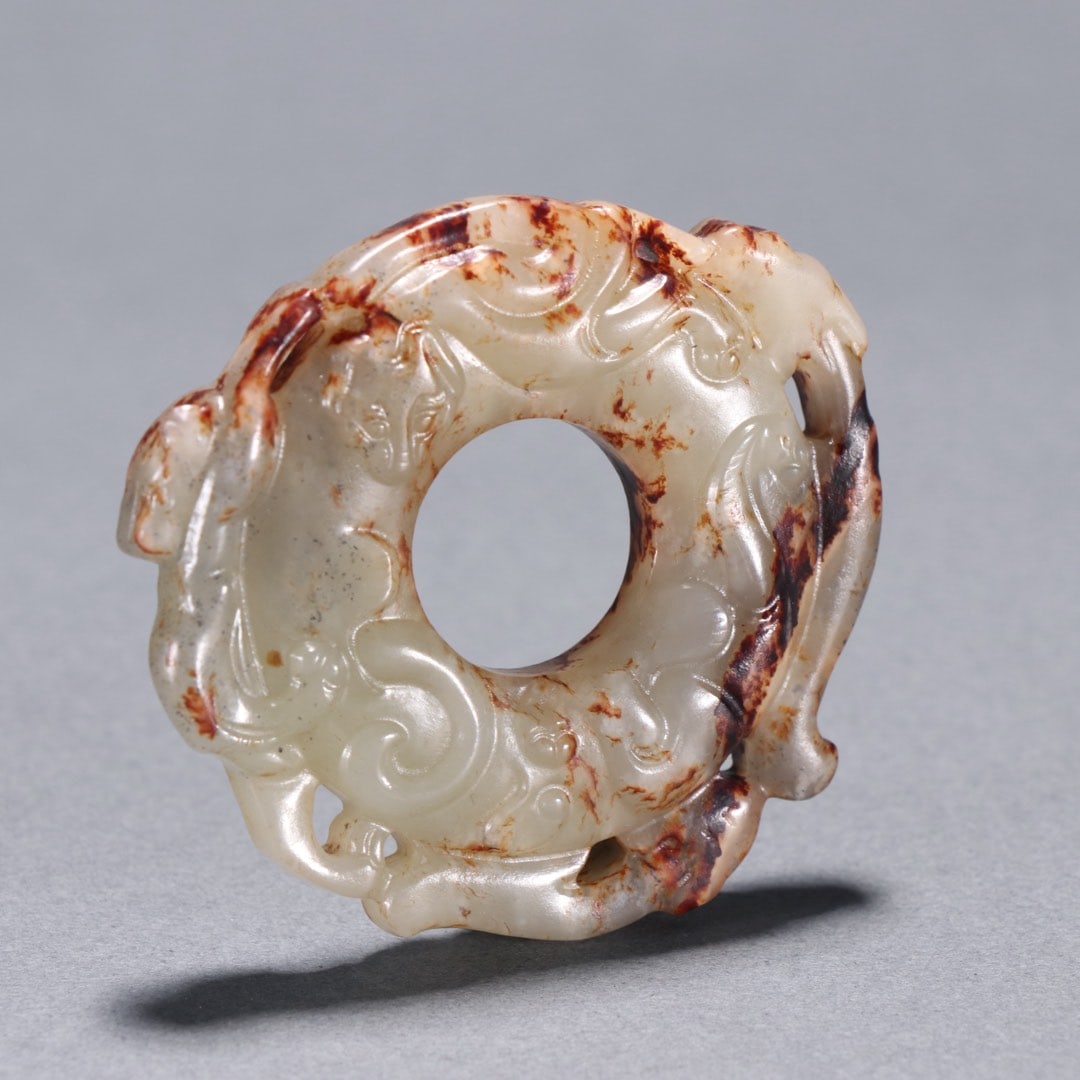 Openwork Bi Disc with Chi-Dragon Pattern, Hetian Jade Carving, Pre-Ming Dynasty: Hetian Jade Bi Disc with Chi Dragon Pattern and Protruding Frame Before the Ming Dynasty, 5.3cm in height, 5.4cm in width and 33.7g in weight. Unearthed from an aristocratic tomb of the Han to