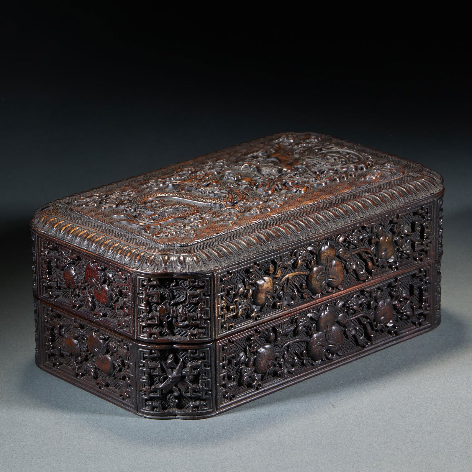 Lidded Box with Dragon, Phoenix and Peach Pattern, Red Sandalwood: Rosewood Covered Box with Dragon and Phoenix and Peach Patterns, 9.5cm in height, 24cm in length, 15cm in width and 922g in weight. Produced by a workshop of the Thirteen Hongs in Guangzhou in the