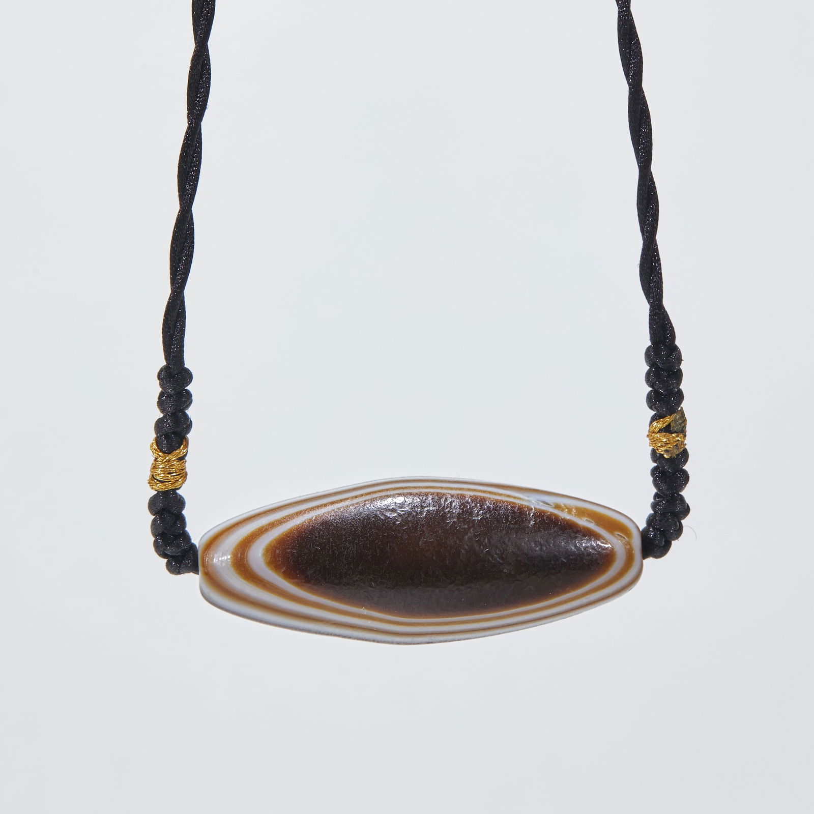 Pendant with Eyed-Eye Dzi Bead, Agate: Agate Dzi Bead Pendant with Eye-in-Eye Pattern, 4.9cm in length, 1.9cm in diameter and 23g in weight, Produced by a workshop in Xizang region or Persian West Asia in the Tang Dynasty, it is an amulet