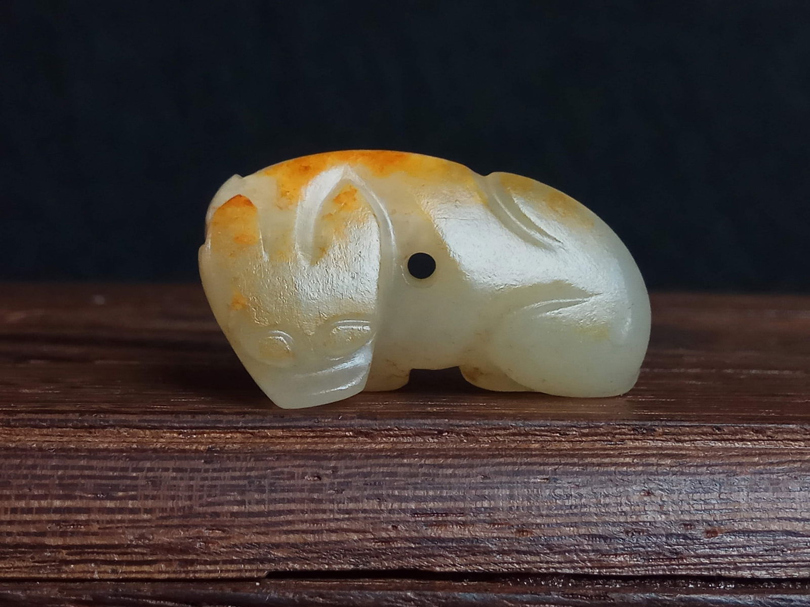 Archaic Jade Dog Pendant, Old Hotan Seed Jade, Shang and Zhou Dynasties: Archaic Jade Dog Pendant, Shang and Zhou Dynasties Hetian Nephrite Seed Material, thickness 1 cm, length 3 cm, width 1.6 cm, weight 5 g. A jade ornament unearthed from noble tombs of the Shang and