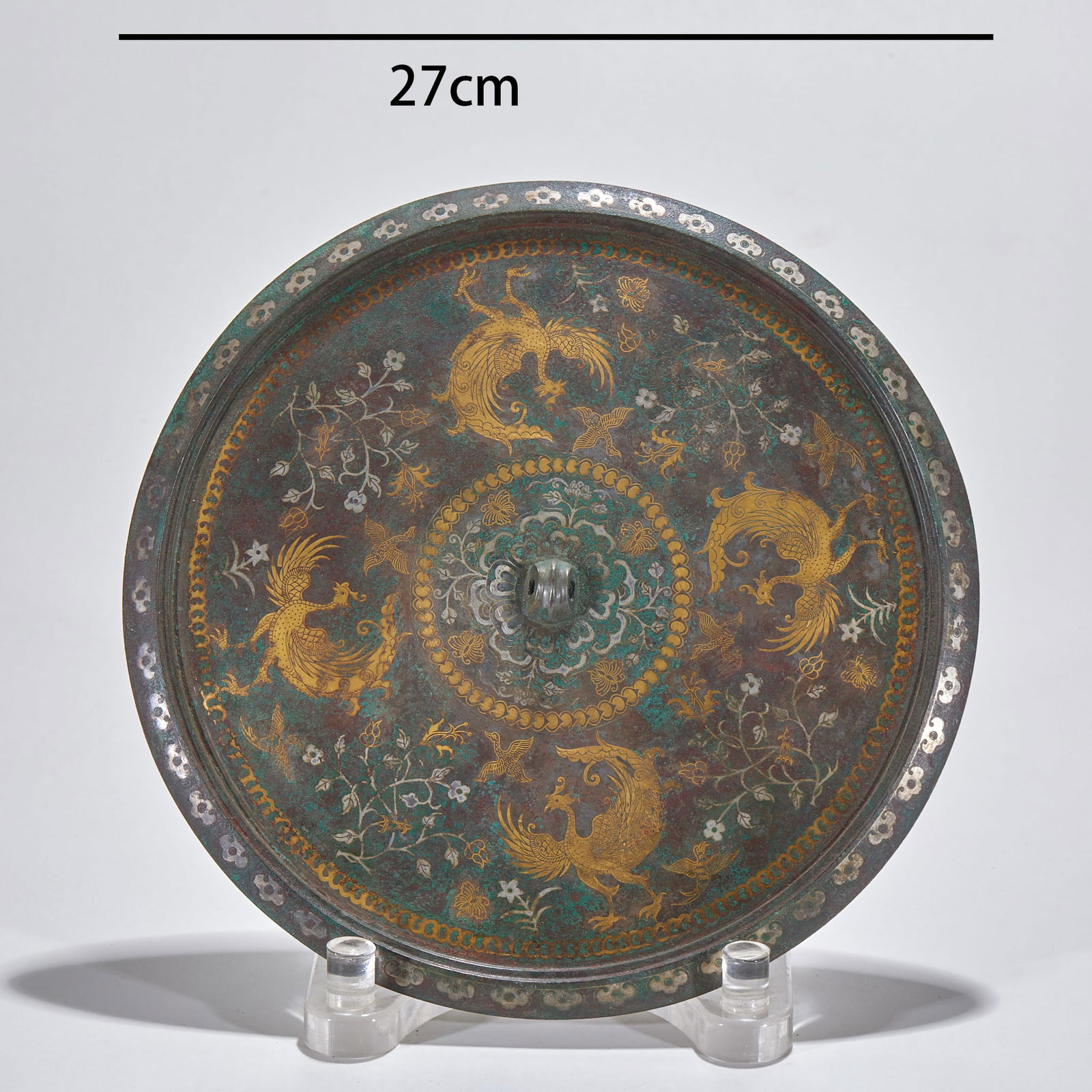 Gold and Silver Inlaid Bronze Mirror with Phoenix Pattern, Pre-Ming Dynasty: Gold and Silver Inlaid Bronze Mirror with Phoenix Pattern (Pre-Ming Dynasty), diameter 27 cm. An imperial bronze mirror of the Tang Dynasty, unearthed from noble tombs in the Chang'an area. The back o