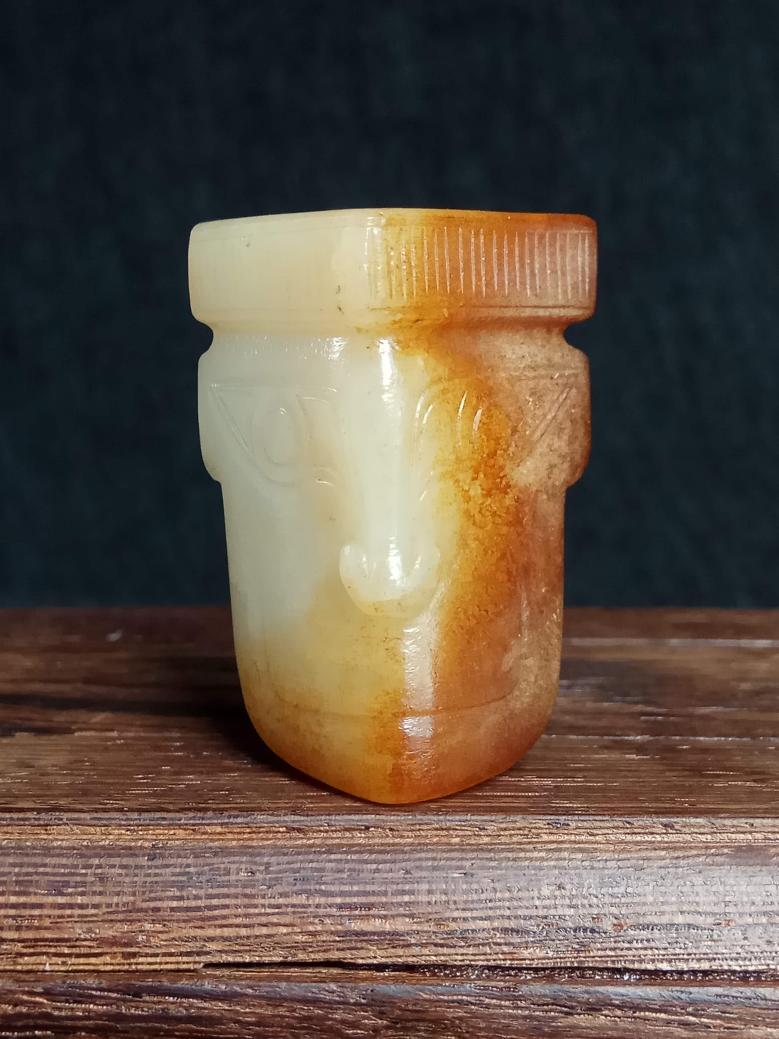 Archaic Jade Pendant with Human-Face Pattern, Old Hotan White Jade, Shang and Zhou Dynasties: Archaic Shang and Zhou Dynasty Hetian White Jade Pendant with Human-Face Pattern, thickness 1.8 cm, length 3.8 cm, width 2.8 cm, weight 24 g. A jade ornament unearthed from noble tombs of the Shang