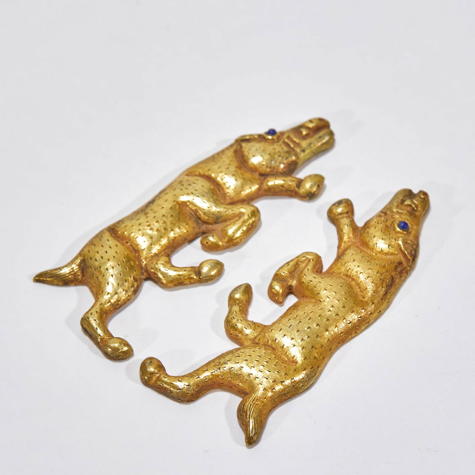 A Pair of Silver Gilt Pig-Shaped Pendants: A Pair of Gilt-Silver Pig-Shaped Pendants, length 6 cm, width 2.5 cm, weight 40 g. Tang Dynasty noble ornaments, unearthed from Tang tombs in Shaanxi. Pure silver gilded, inlaid with sapphires for