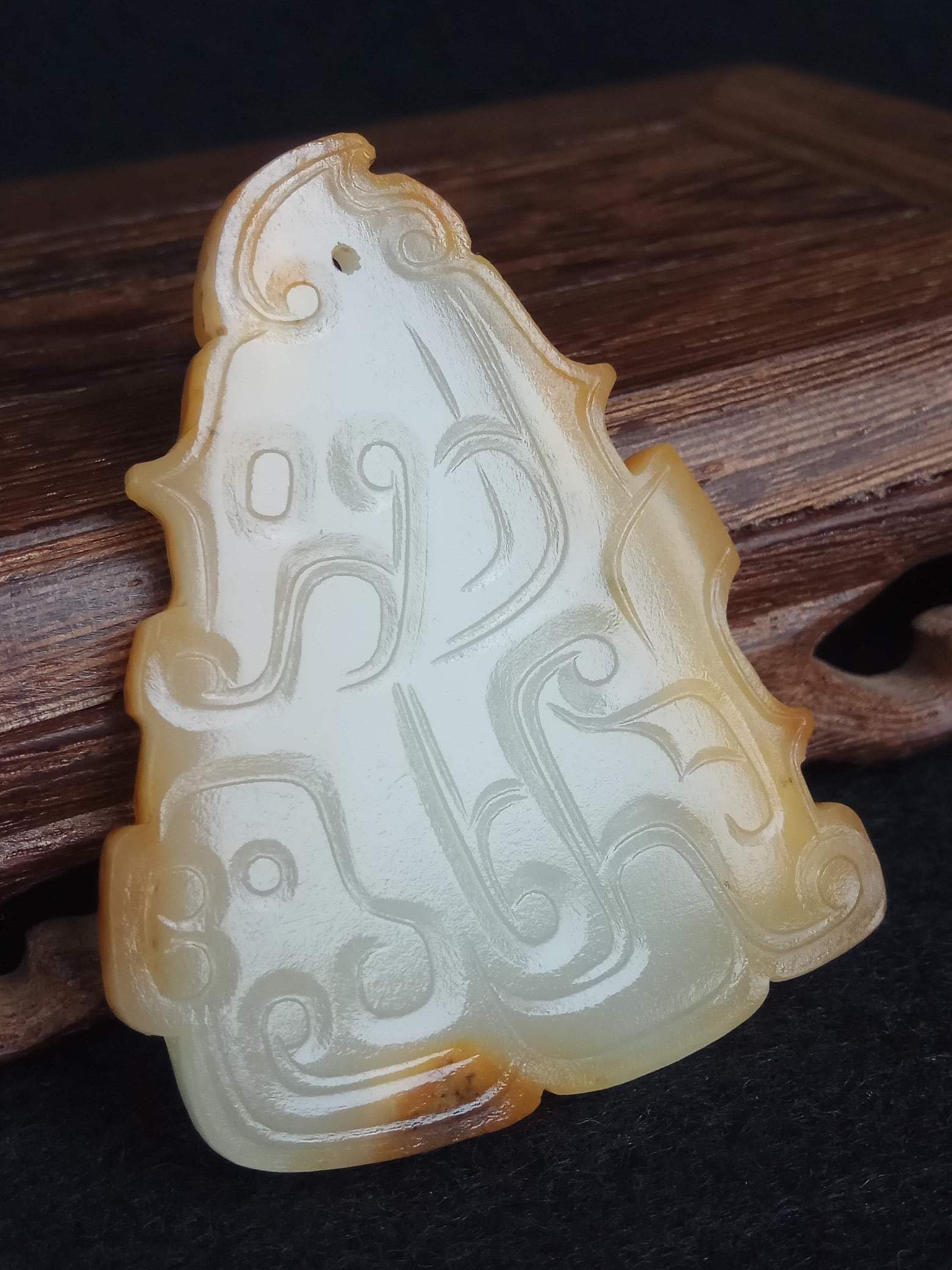 Archaic Jade Bi Disc Pendant with Human-Dragon Pattern, Hotan Seed Jade, Shang and Zhou Dynasties: Archaic Shang and Zhou Dynasty Hetian Jade Seed Material Bi Disc Pendant with Human-Dragon Pattern, thickness 2.4 cm, length 5.4 cm, width 4.5 cm. A jade pendant unearthed from noble tombs of the