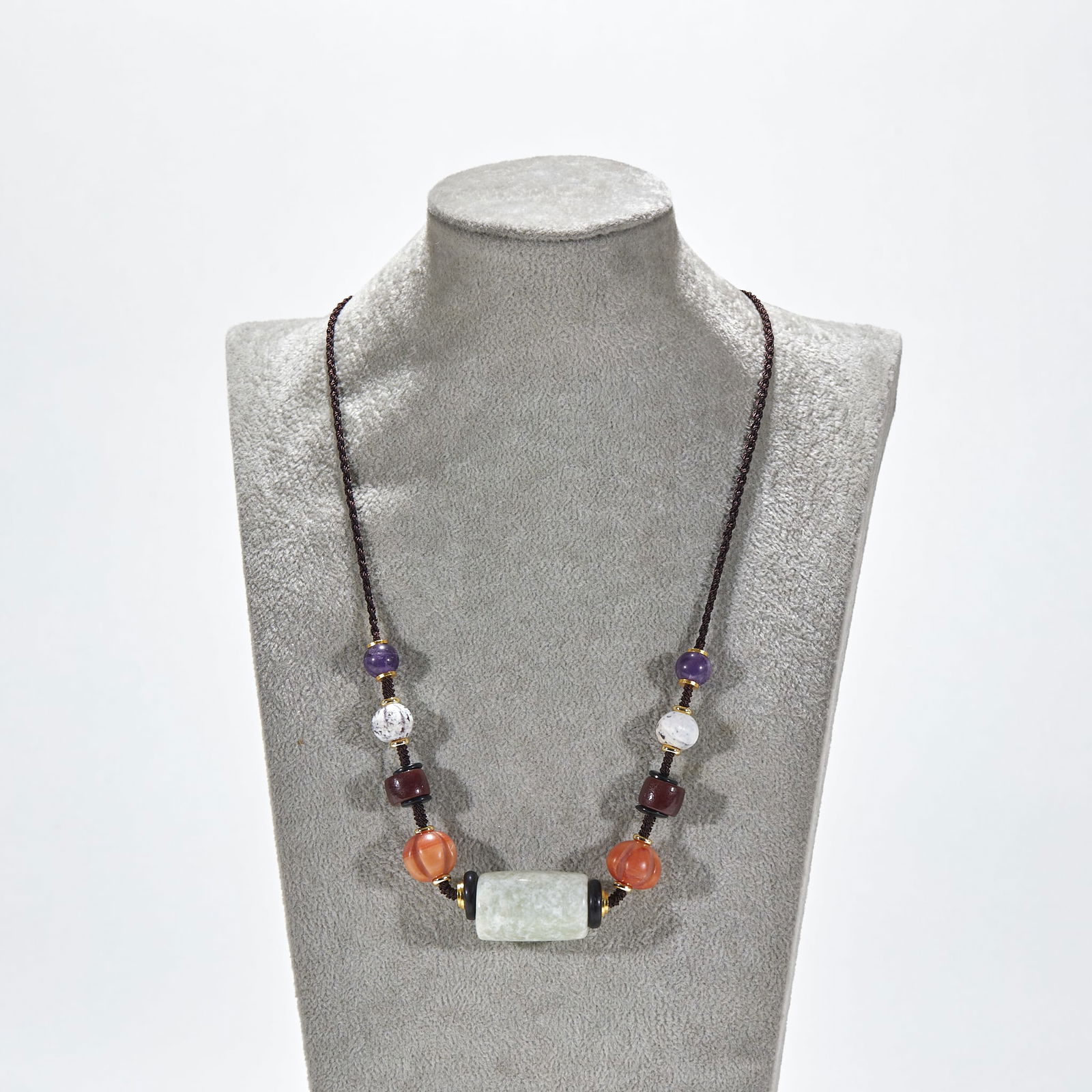 Hongshan Culture jade roller with agate and amethyst pendant: Hongshan Culture Jade Roller Pendant with Agate and Amethyst. Roller length 3.2cm, width 2cm. The main jade roller is a relic from the Hongshan Culture (Neolithic Age), later redesigned and matched