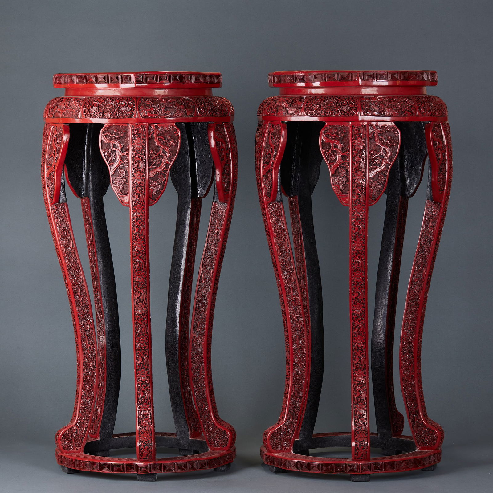 A pair of carved red lacquer flower stands: Pair of Carved Red Lacquer Flower Stands, Qing Dynasty. Height 83cm, diameter 40cm. Made by the Qing Imperial Workshop or high-end Suzhou lacquer workshops for hall display. Wood body coated with