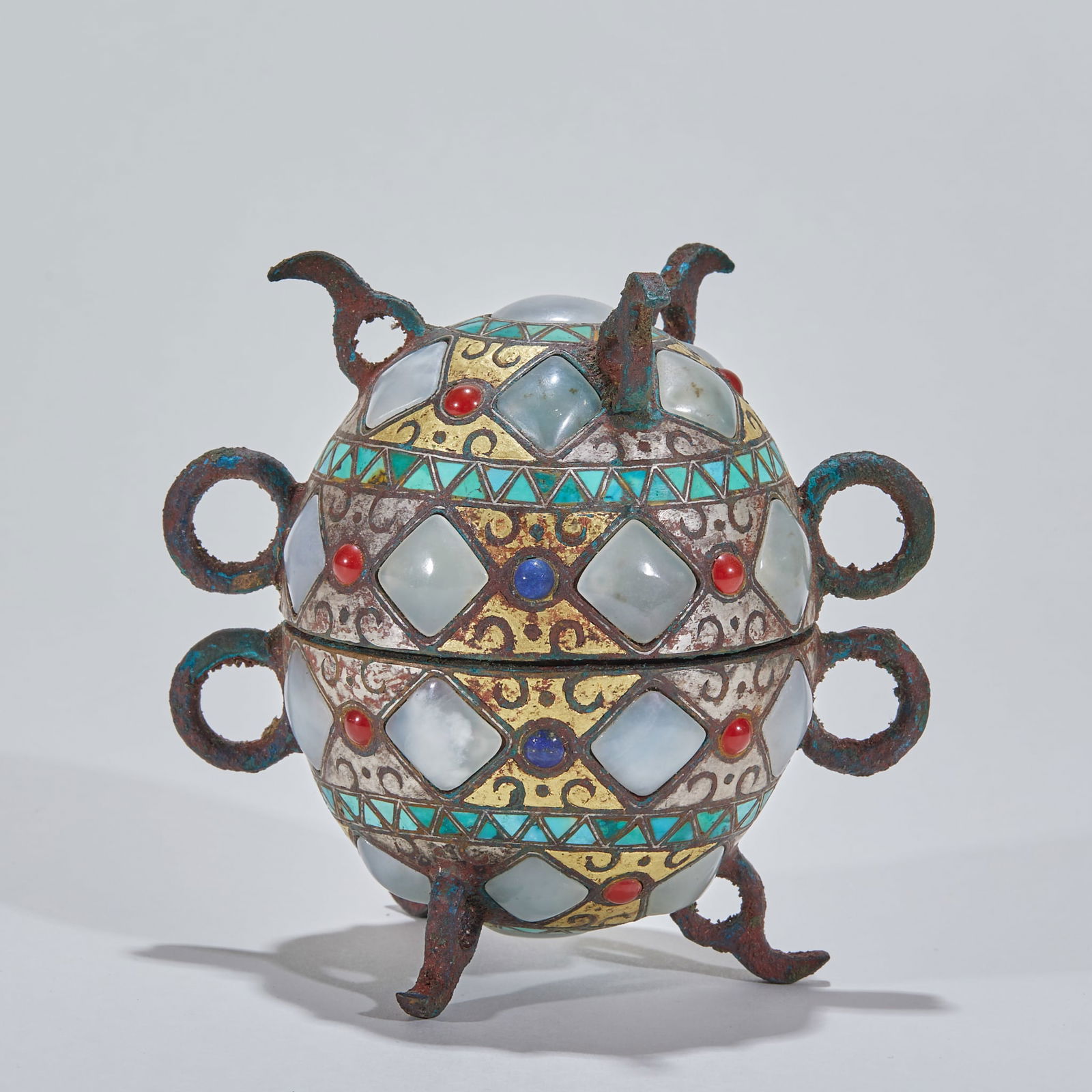 Inlaid gold and silver, jade, turquoise and bronze weapon: Gold and Silver Inlaid Bronze Vessel with Jade and Turquoise. Height 11.5cm, diameter 11.5cm. Warring States to Han Dynasty, a noble ritual or practical vessel influenced by Western culture. Bronze
