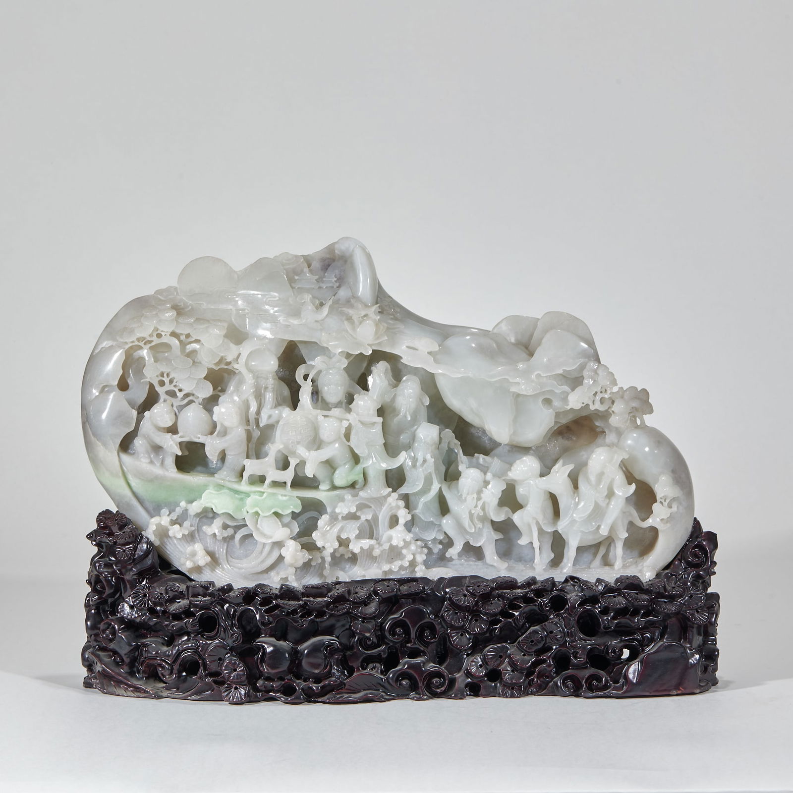 Andaite jade mountain with figures under a pine tree: Hotan Jade Mountain Carving: Figures Under Pine. Height 30cm, length 40cm, width 9cm. Qing court or scholar’s studio display, a natural skillful carving by jade masters. Hotan white jade (with light