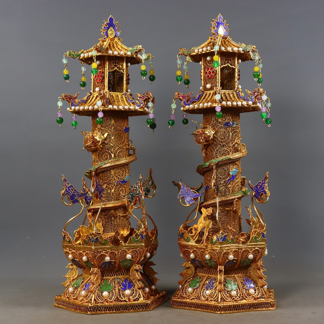 A pair of Qing Dynasty gilded and inlaid gemstone coiled dragon columns: Pair of Qing Filigree Gilded Gemstone Inlaid Dragon Pillars. Height 36.5cm, diameter 14cm, weight 2090g. Qing court or royal temple offerings made by the Imperial Workshop. Gilded silver (or copper)