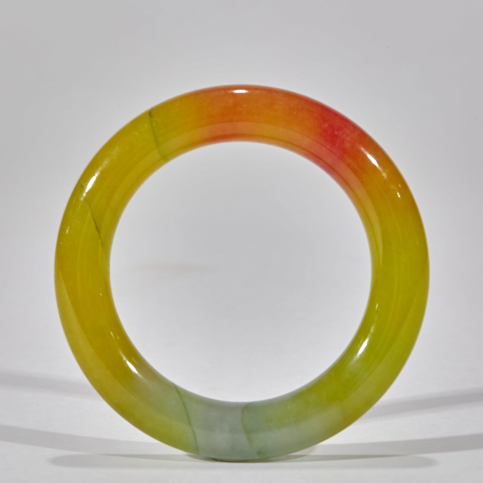 Multicolored Jadeite Bracelet: Multi-Color Jadeite Bangle. Outer diameter 8.5cm, inner diameter 5.8cm, weight 97g. Qing court or noble ornament, "Fu-Lu-Shou" three-color jadeite (yellow, red, green). Jadeite (hard jade) with natura