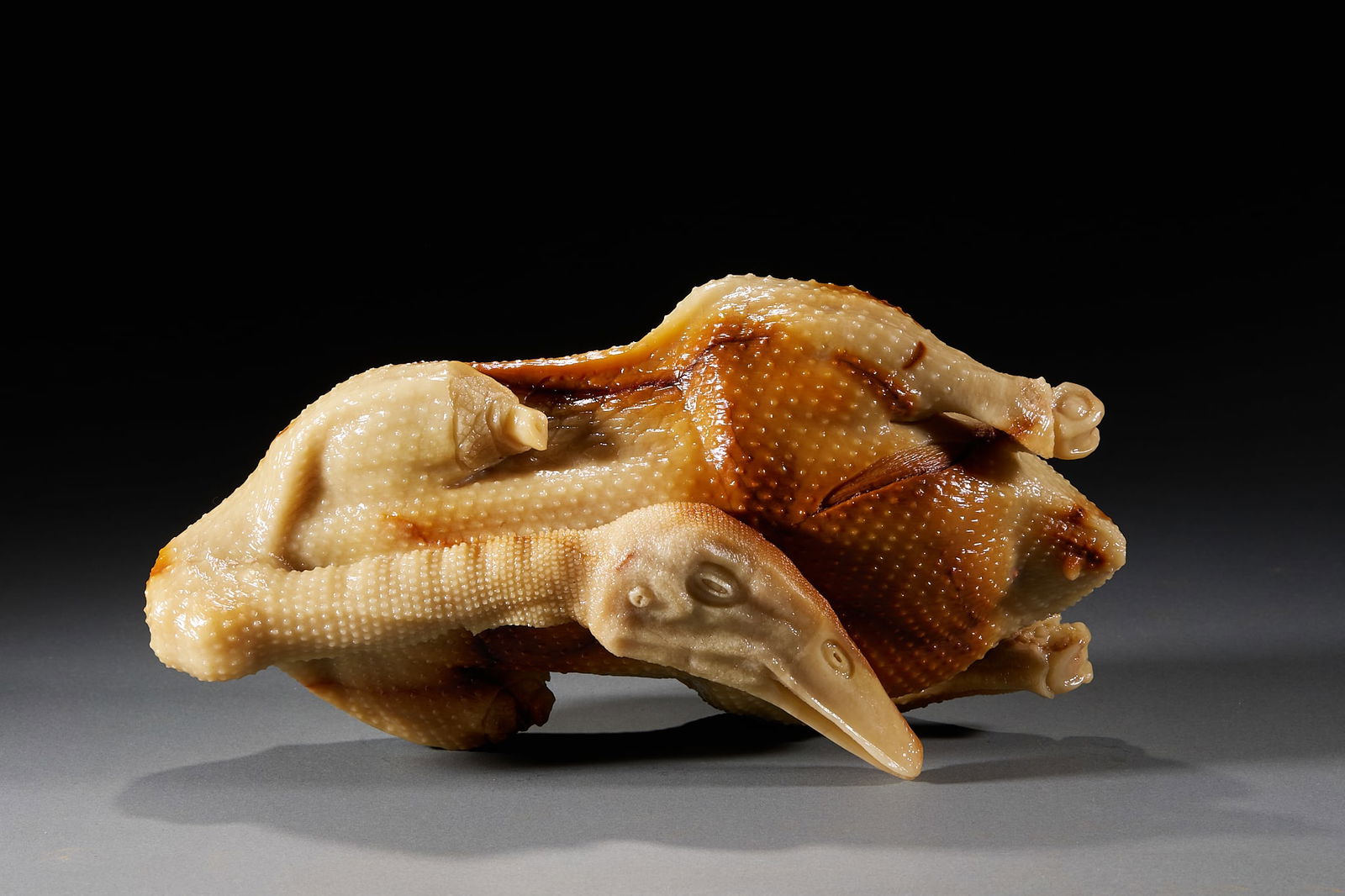 Shoushan stone carving of a full banquet with a lion-headed goose: Shouhua Stone, Full Chinese and Manchu Feast. Lion Head Goose, height 11cm, length 32cm, width 16cm, weight 6320g. This modern Shouhua stone sculpture artwork belongs to the "Full Chinese and Manchu