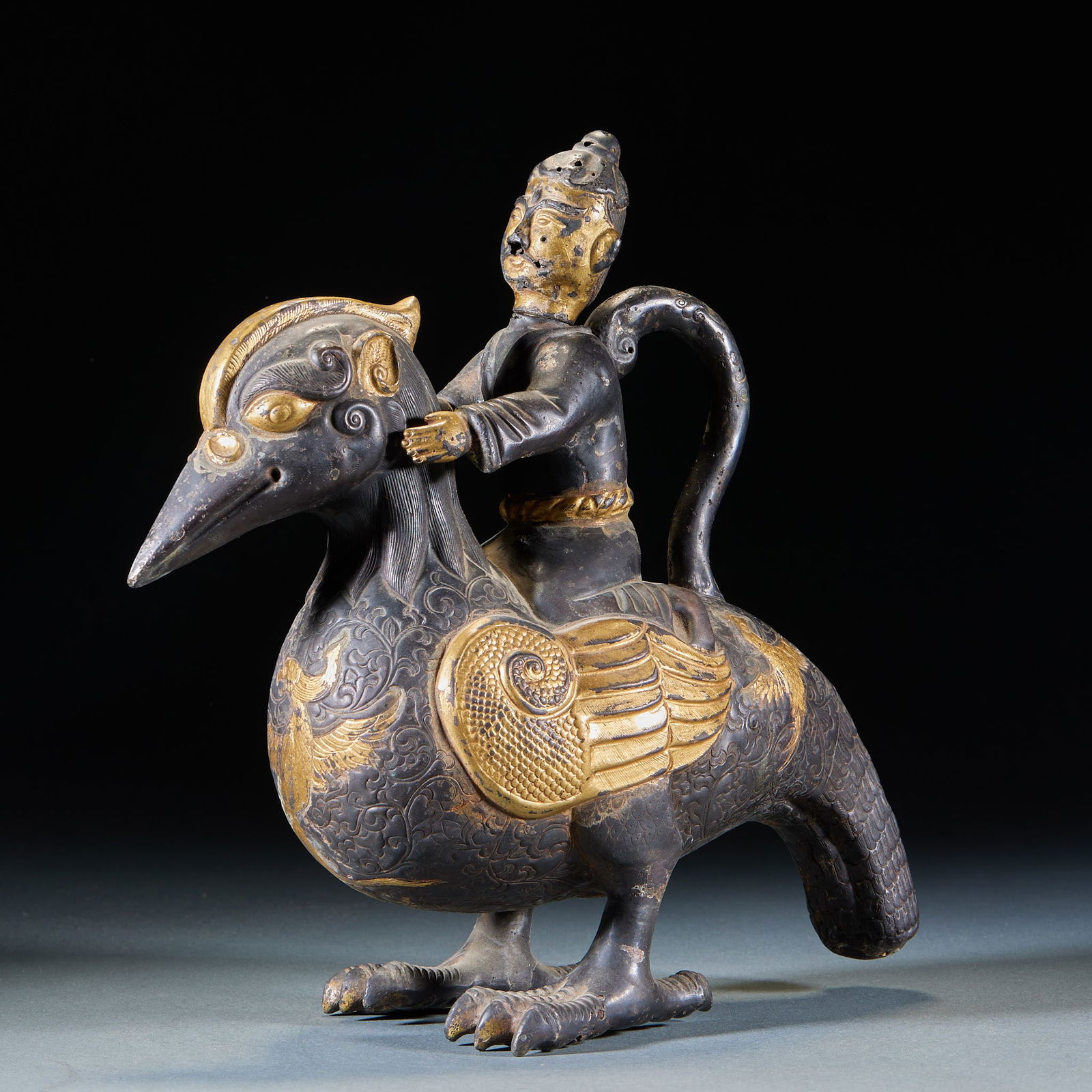 Gilded Bronze Ornament of Figures and Auspicious Beasts: Copper Gilded Figure and Beast Decorative Piece, Height 23 cm, Length 23 cm, Width 9.5 cm. This is a court decorative piece from the Tang or Liao-Jin period, influenced by Persian culture. Copper