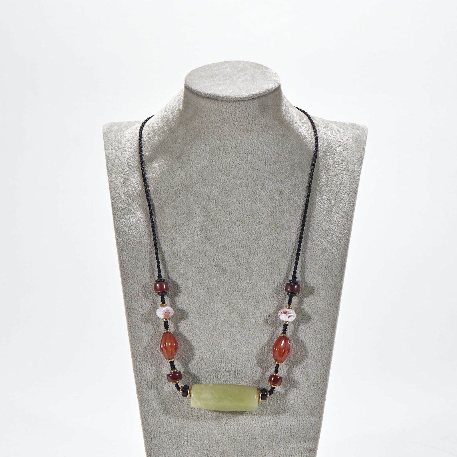 Hongshan Culture Jade Roller Agate Pendant: Hongshan Culture Jade Roller and Agate Pendant, roller length 5cm, width 2cm. A ritual or decorative jade object of the Neolithic Hongshan Culture (c. 4000–3000 BCE), later strung with agate beads.