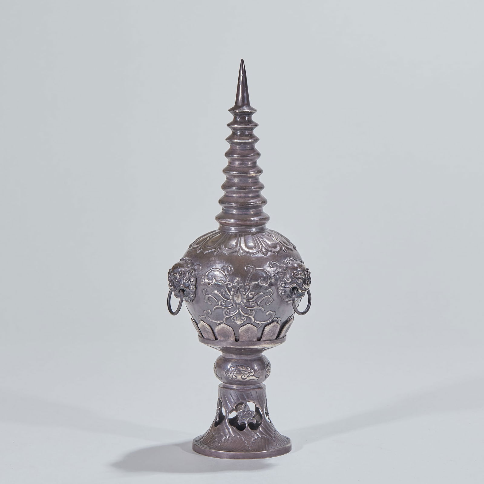 Silver Pagoda with Lion Ears: Silver Pagoda with Lion Ears, height 22.5cm, diameter 8cm, 243g. A ritual vessel for Tibetan Buddhist temples of the Qing Dynasty. Silver body with chiseled patterns. Crafted with hammering,