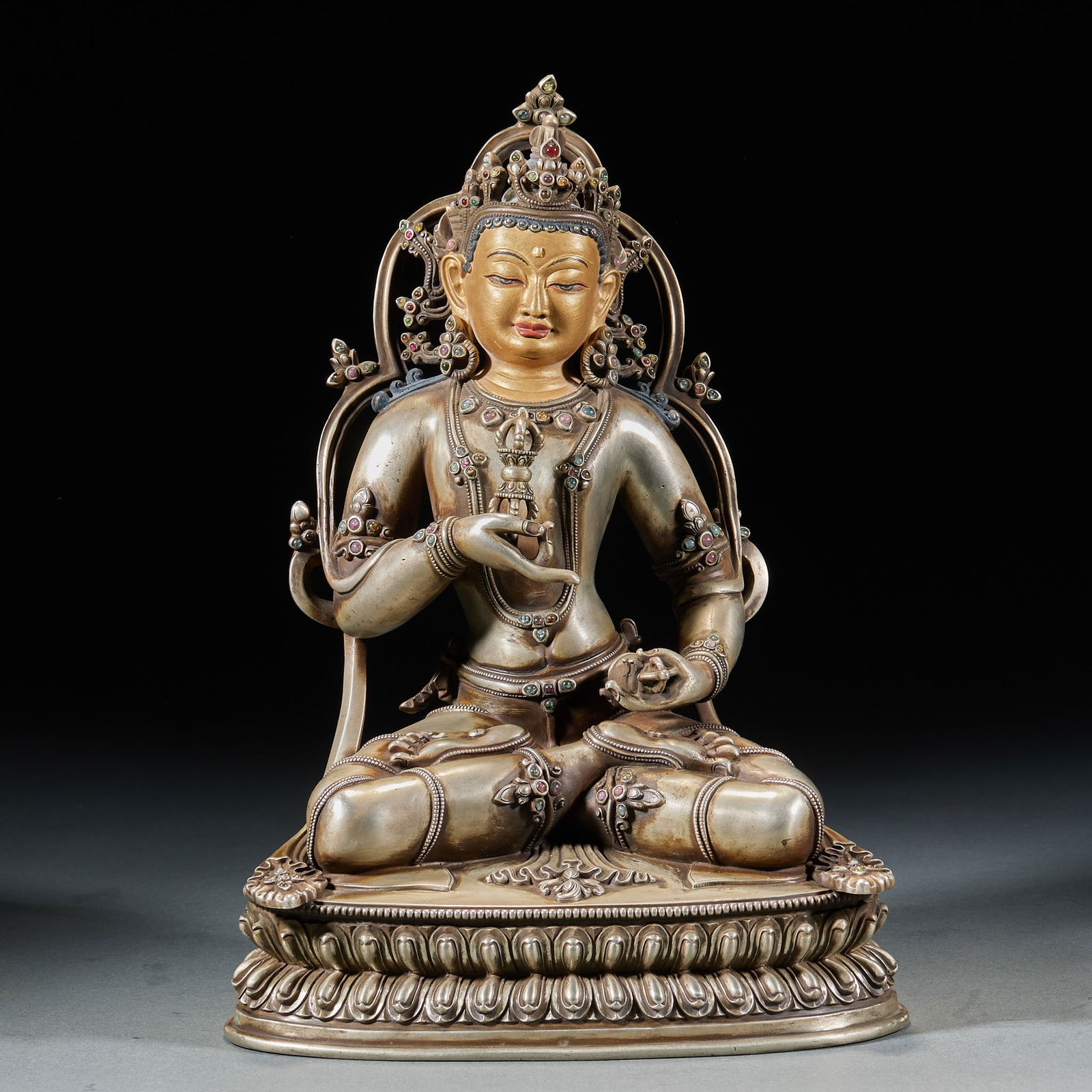 Silver Inlaid Statue of Vajrasattva: Silver Inlaid Vajrasattva Statue, height 26.5cm, length 19cm, width 12cm, 3050g. A Qing Tibetan Buddhist Vajrayana deity statue. Silver, gilded, inlaid with rubies and turquoise. Made with hammering,