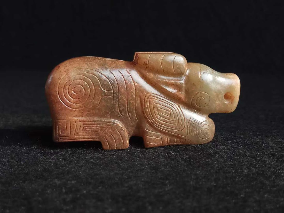 Hetian Jade Ox: Hetian Jade Ox, Thickness 1.5cm, Length 6.8cm, Width 2.9cm, 49g. An ancient Chinese auspicious beast ornament originating from the jade culture of prehistoric, Shang and Zhou dynasties, symbolizing di