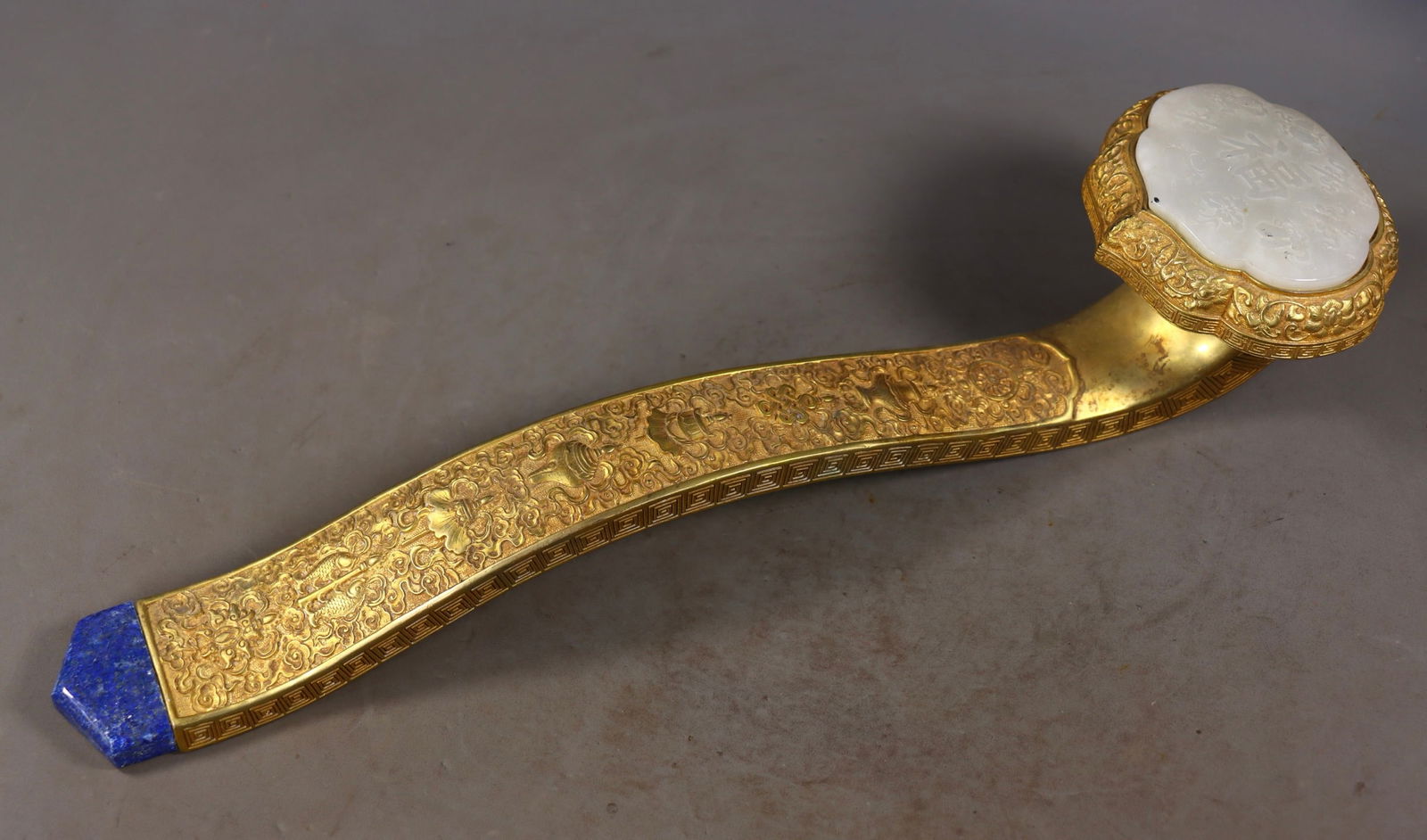 Hetian Jade and Lapis Lazuli Ruyi Scepter Inlaid with Copper Gilding: Gilded Bronze Ruyi Inlaid with Hotan Jade and Lapis Lazuli, height 8.5cm, length 40cm, width 10cm, weight 1300g. Made by the Qing dynasty Imperial Workshop, a royal gift, display or ritual vessel from