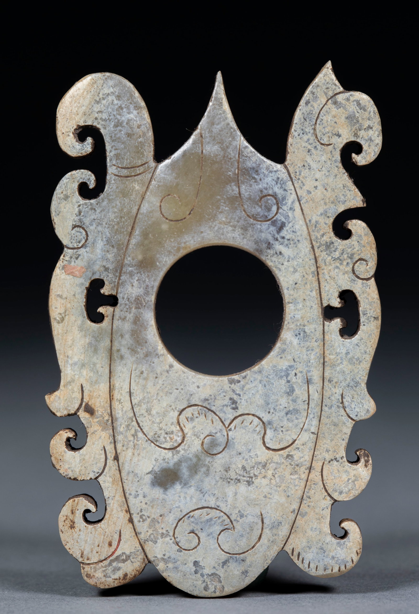 Dish-Shaped Pendant: Archer-shaped Pendant, Warring States-Han Dynasties, H.0.5cm L.6.5cm W.4cm 27g. Ancient jade ritual or ornamental object, unearthed or handed down; natural Hotan celadon jade with natural