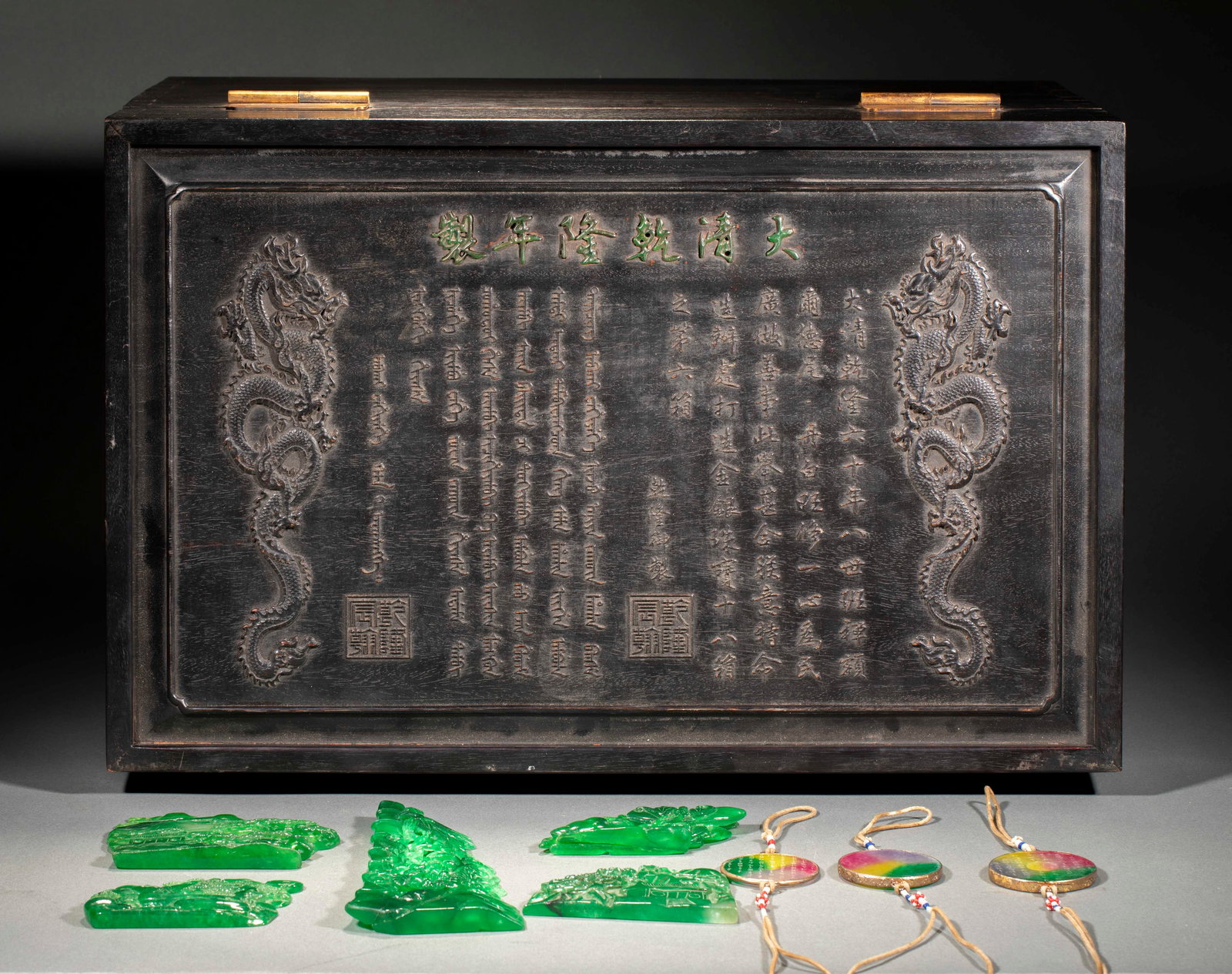 Box of Jadeite and Jewellery, Mark of Da Qing Qianlong Nian Zhi: Box of Imperial Jadeite and Jewels, Qianlong Period, Qing Dynasty, Box H.35cm L.56cm W.36.5cm Pendant Thickness 0.5cm Diam.5.4cm. Qianlong imperial jadeite and jewels, handed down, complete set with