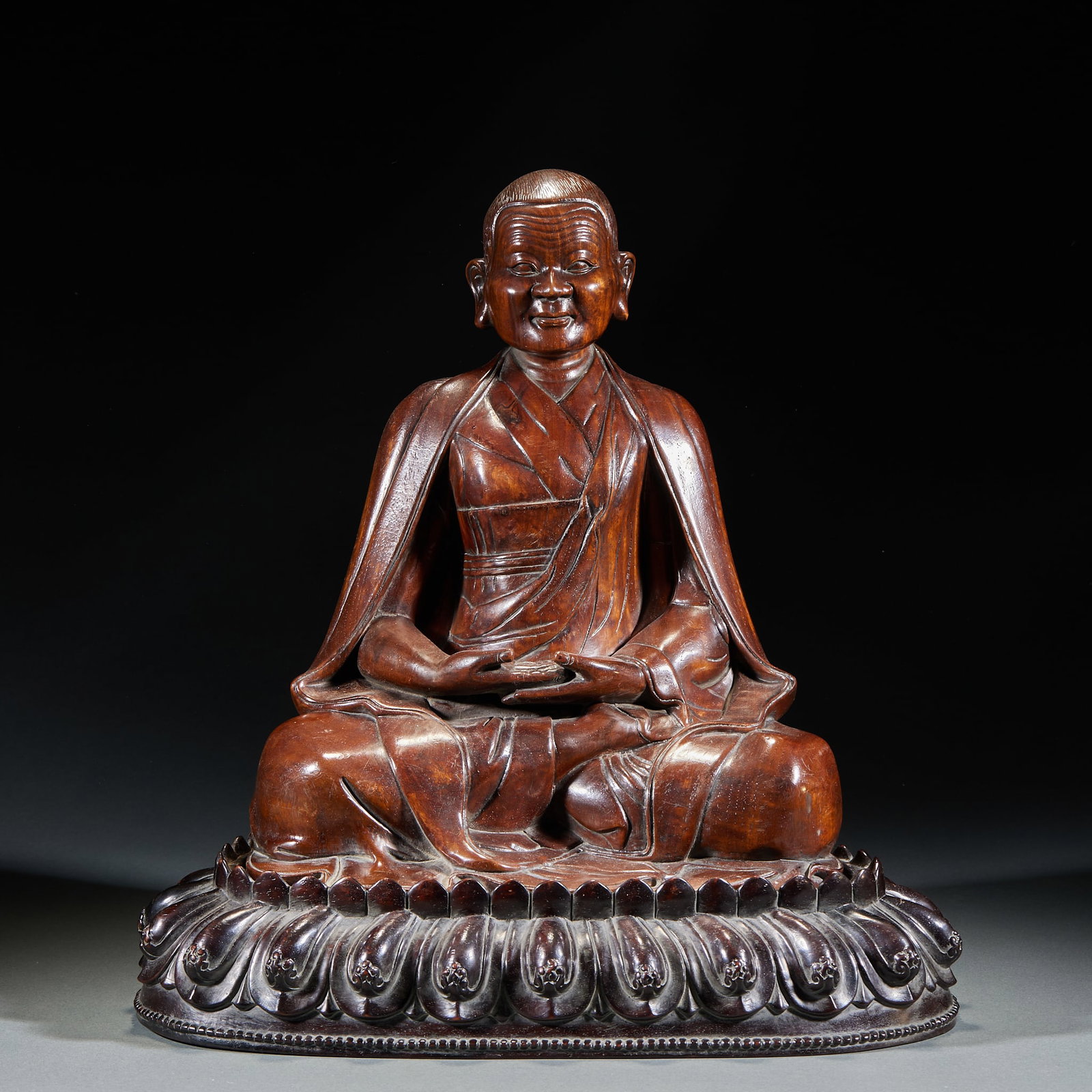 Huanghuali Seated Statue of Guru Buddha, Qing Dynasty: One Qing Dynasty huanghuali Guru Buddha statue, H. 37cm, L. 35cm, W. 26cm, Qing Dynasty (huanghuali Buddhist ritual statue, hereditary); natural Hainan huanghuali; carved in round relief as a seated