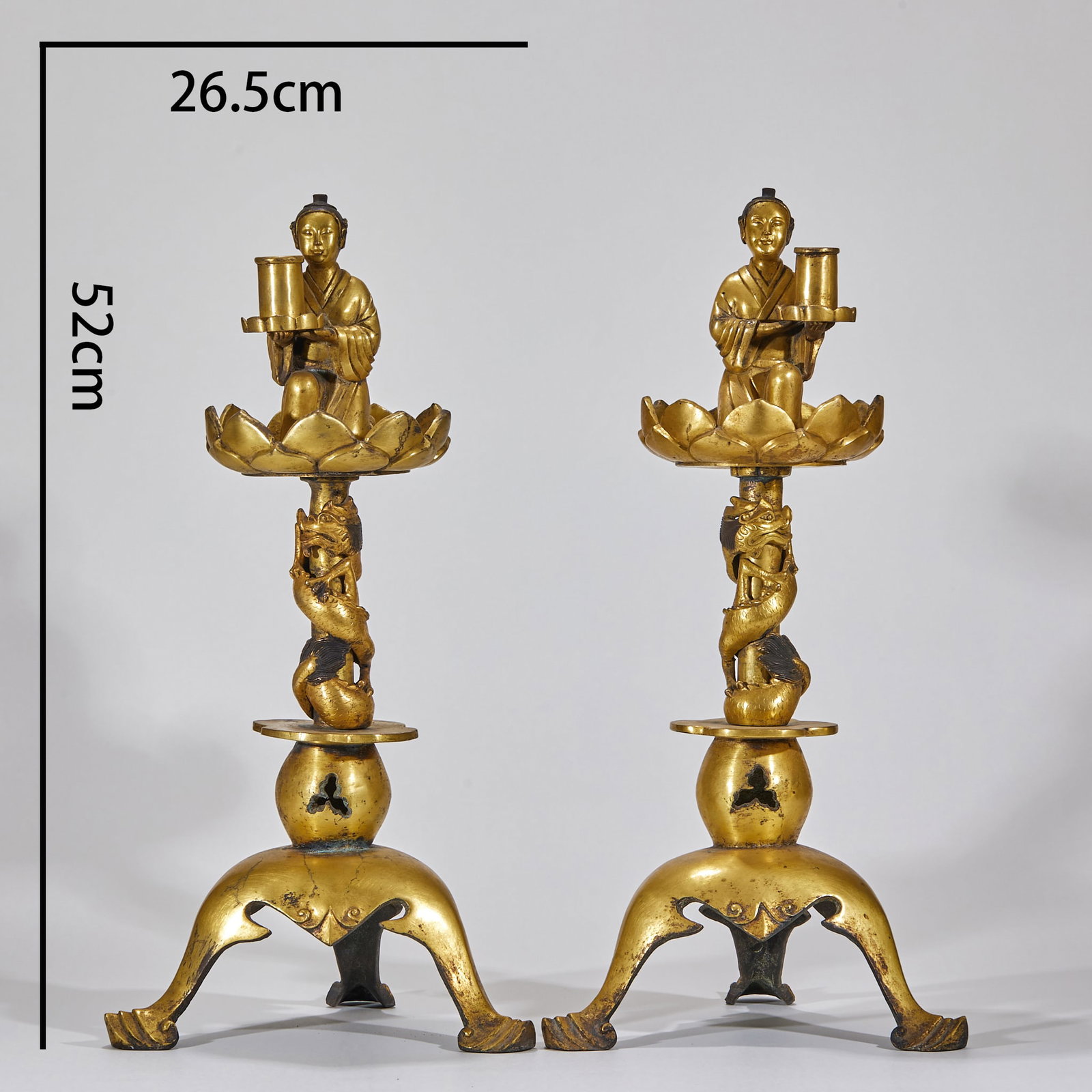 A pair of noble Panlong candlesticks in Liao Dynasty: Copper gilding, in pairs, with a height of 52 cm and a width of 26.5 cm. Three-legged outward-swinging base, the base is hollowed out, and the gourd-shaped component is accepted upwards. The upright c