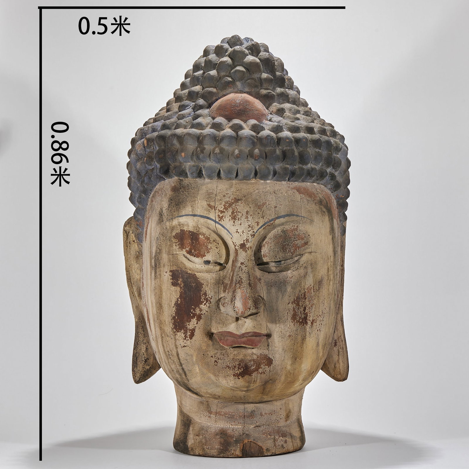Woodcarving Buddha head of Sakyamuni: Woodcarving Buddha's head, with a height of 0.86 meters and a width of 0.5 meters. The spiral hair is regular, the bun is raised, the eyes are drooping, the face is peaceful, and the ear and nose are