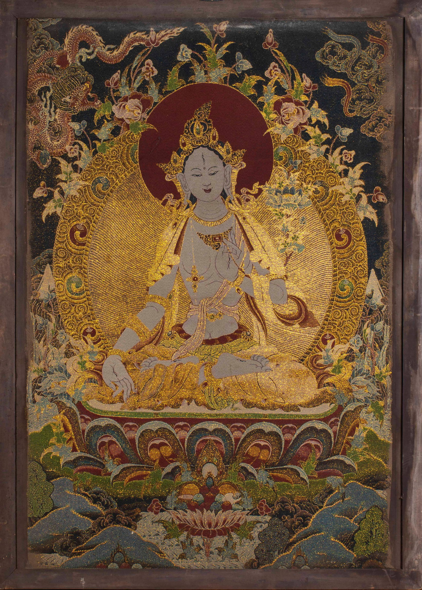 Before the Ming Dynasty, cypress silk was hung in White Tara.: Fabric base, embroidered with gold thread and colored thread in White Tara. Tara sits on the lotus throne, wearing a crown and a full set of bracelets, giving vows in her right hand and holding Ubara