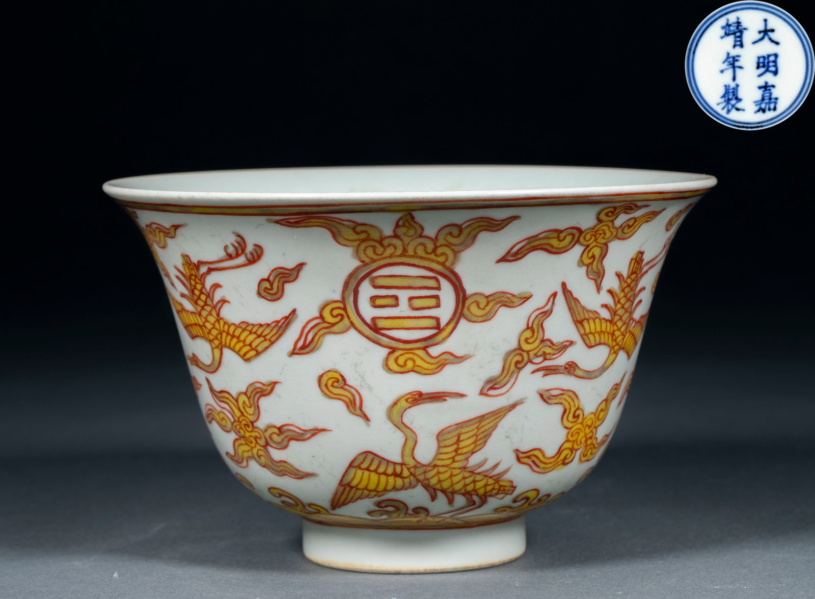 Ming Jiajing Fanhong Gold-painted Crane Bowl: Open, arc wall, circle foot. The outer wall is made of white glaze, painted with red and yellow colors, and painted with auspicious clouds, flying cranes and bagua symbols. The posture of the crane