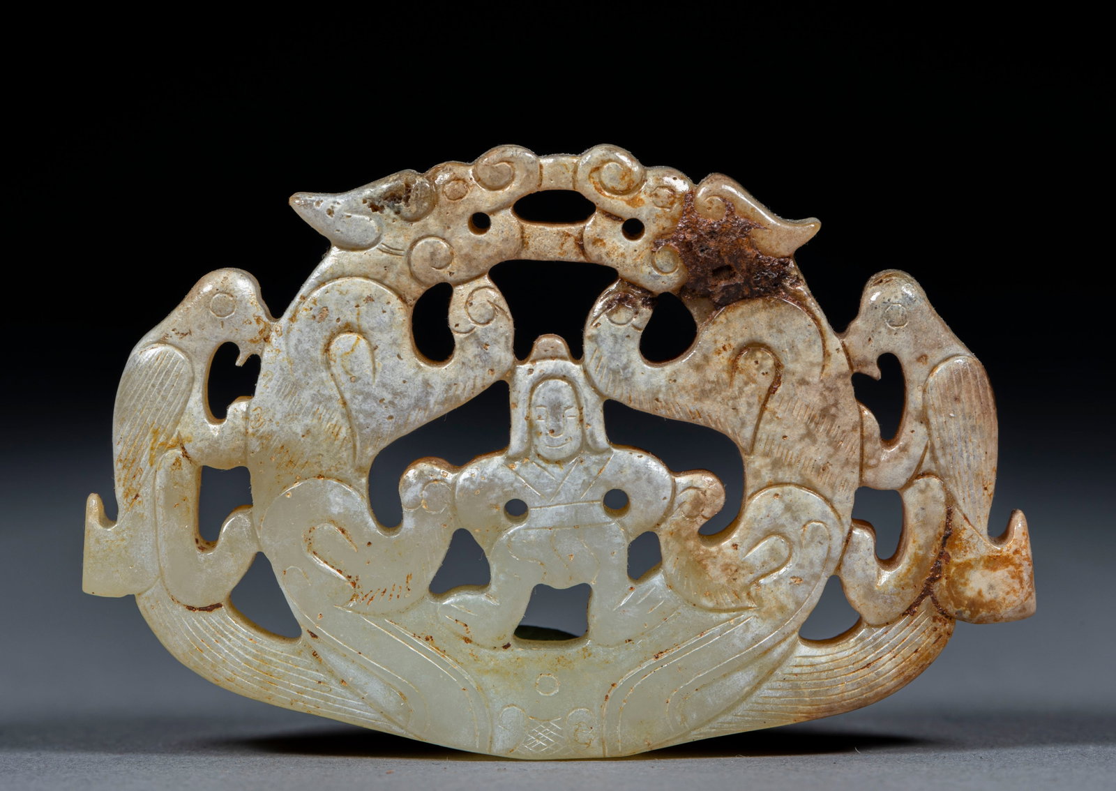 Yu Pei, a hollow tiger figure.: Jade openwork ornament, with an overall arc profile. Carve a man sitting on his knees in the center, carve a double dragon symmetrically on both sides, carve a phoenix bird on the outside of the