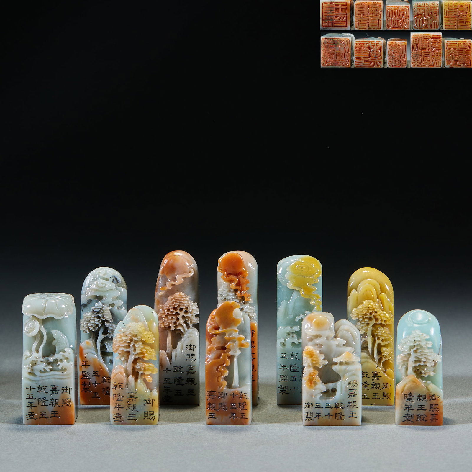 Shoushan stone landscape button seal group of ten.: There are ten seals in total, and the texture of Yin Shi is colorful, with white, yellow, orange, blue and green colors. The top of each seal is embossed with landscapes, trees, and the scenery of