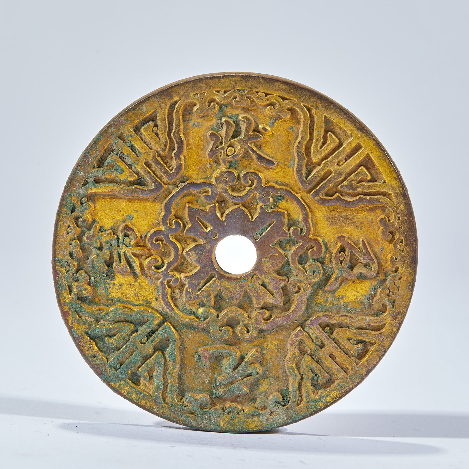 Giving birth to your son early and spending money: Round copper coin with a round hole in the middle. The objects are covered with gold, and the surface is covered with patina rust. The center is eight petal flower pattern, and six groups of Sanskrit