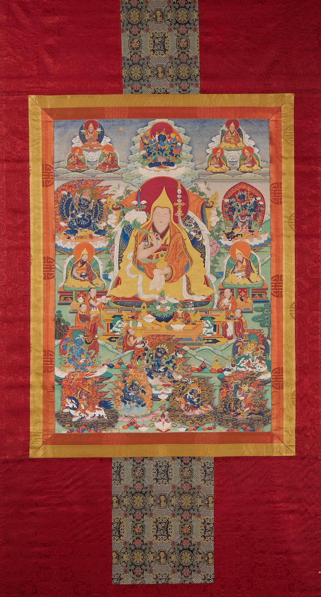 Zong Kaba Tangka: Complete original brocade mounting cover, decorated with red brocade, with colorful brocade streamers on the top and bottom. The master of the picture is a guru of the Gelug Sect, wearing a yellow