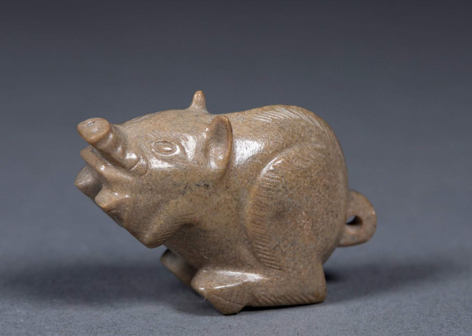 Jade pig: Jade carving, shaped like a wild boar. Head held high, mouth extended forward, ears stood up, limbs crouched, tail perforated, the surface of the instrument is engraved with negative lines to show