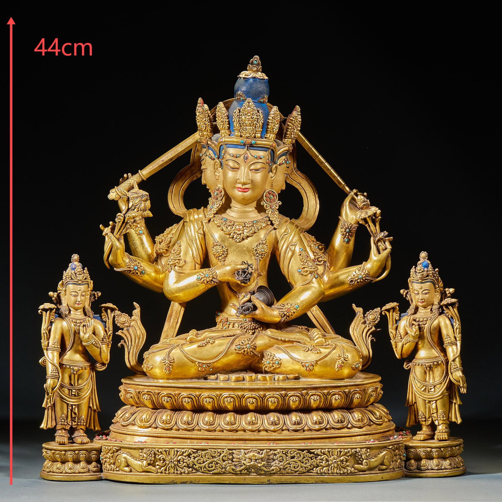 Bronze gilt inlaid with turquoise manjusri bodhisattva: It is 44 cm high, cast in copper and gilded. The statue is made of three sides and six arms, with a crown on the head, a high bun, and big ears. The whole body is decorated with bracelets and