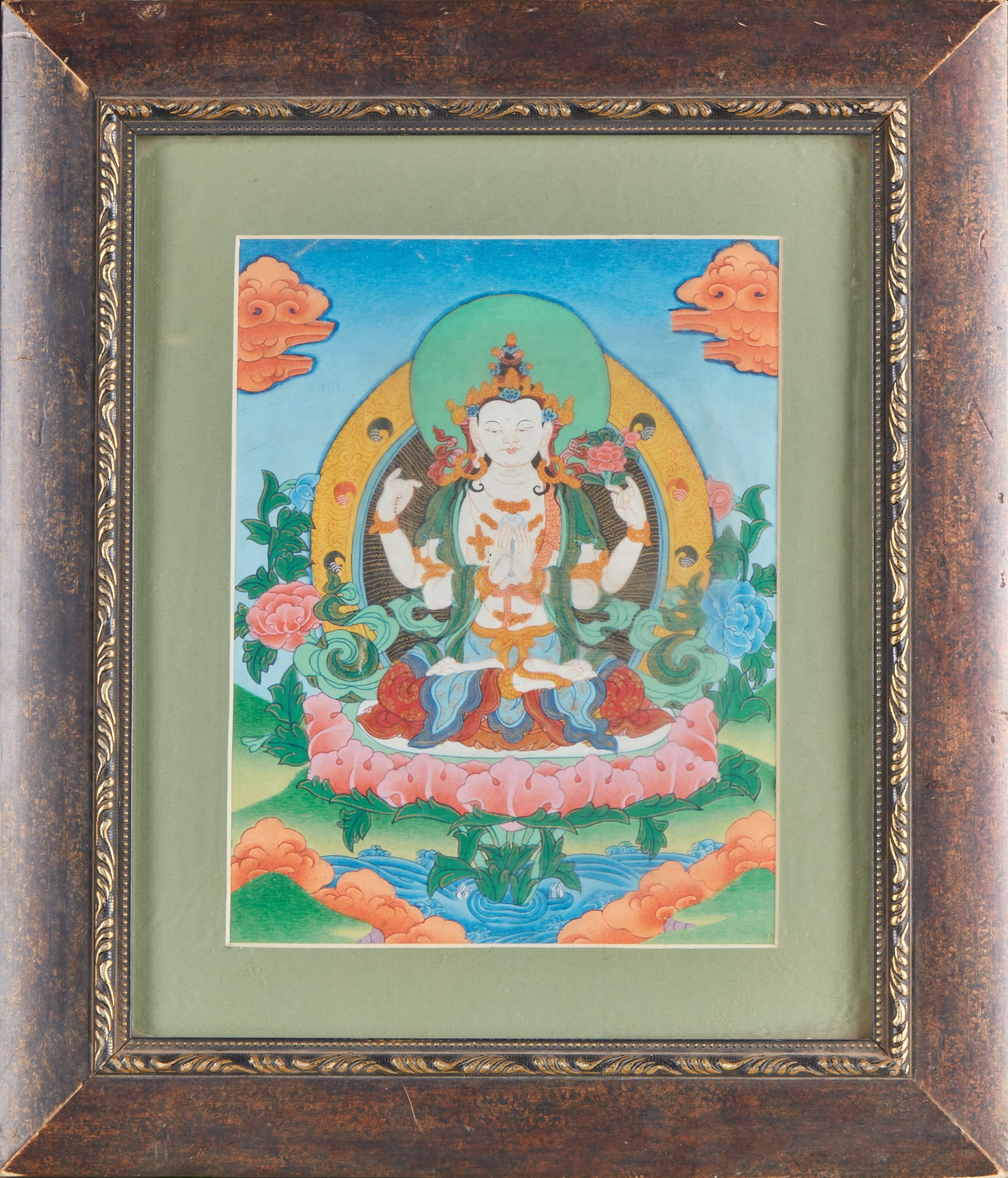 Four-armed Guanyin Thangka: Mounted frame thangka, the outer frame is made of old carved wooden frame, lined with green cardboard. The master of the picture is Guanyin with four arms, sitting in a huge pink lotus seat, with four