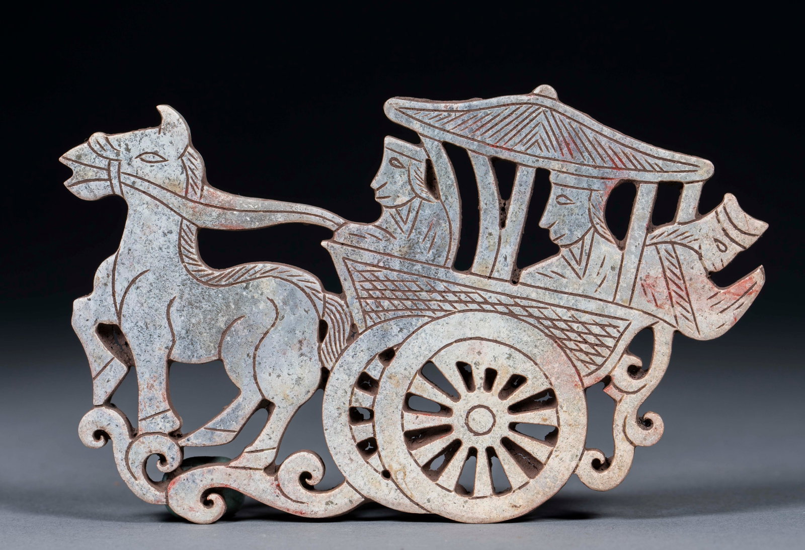Hollow carriage jade jade: Ancient jade texture, the whole piece is hollowed out. The picture depicts a horse-drawn chariot, the steed moves forward, the chariot has an umbrella cover, and the charioteer and the rider are