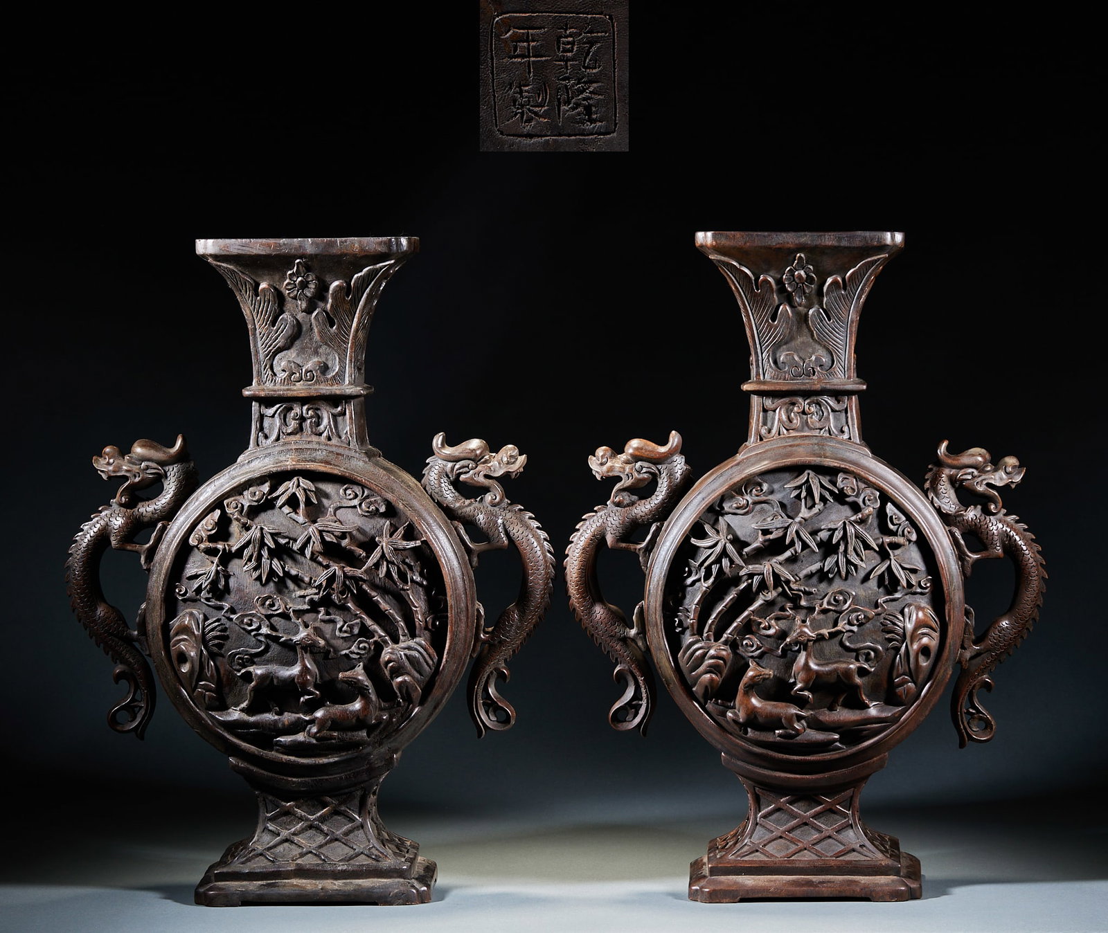 A pair of agarwood pine deer and spring dragon ear bottles: Carved from the whole wood, the vessel has a curled mouth, a neck, a flat belly and a square circle. The neck is carved with flowers and birds, the sides of the bottle are carved with