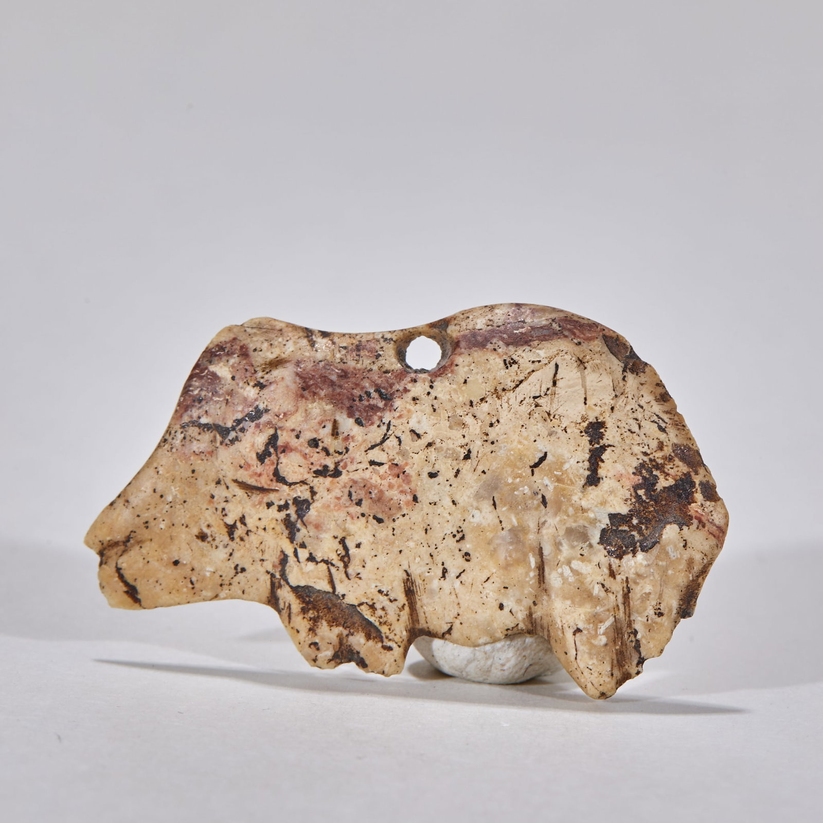 Hetian jade beast before Ming dynasty: Flaky jade animal-shaped dress, showing the side view of animals, with incomplete outline edge. The jade material has a beige background, with a large area of reddish brown and dark brown spots. The
