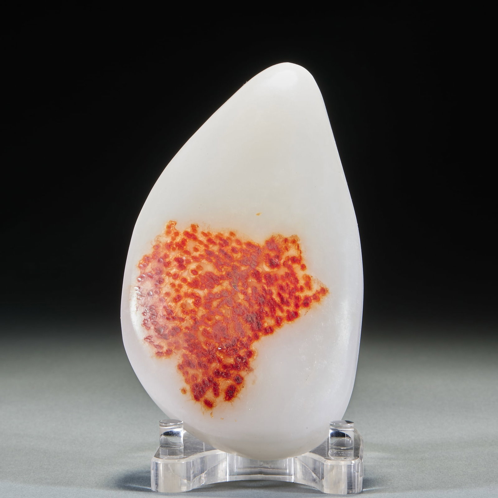 Hetian jade original stone: Hetian jade seed material, the overall drop-shaped, jade background white and moist, one side gathered a large orange-red natural skin color, the skin is covered with fine red spots. The jade