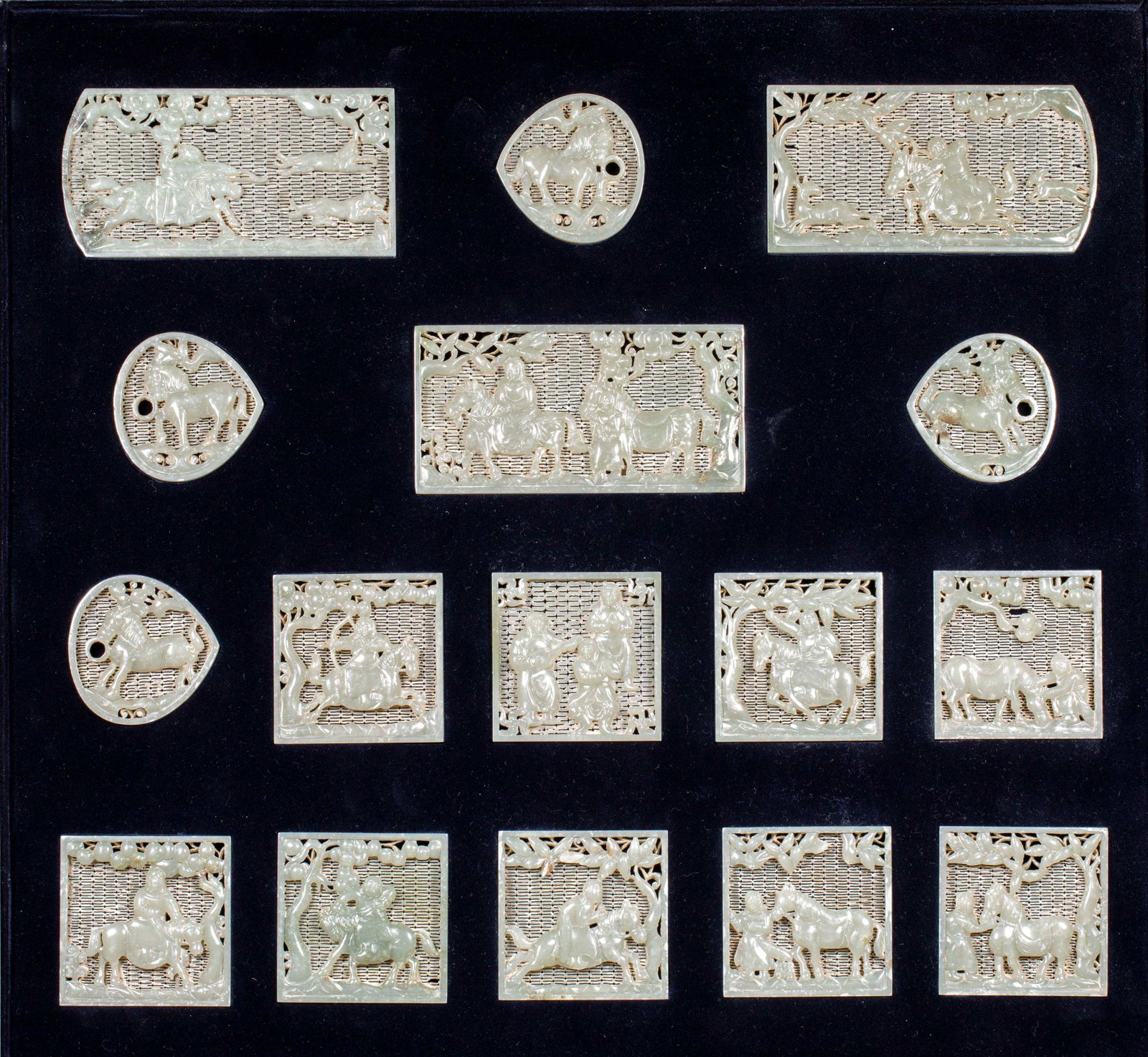 A set of jade belt boards for Qidan character stories before the Ming Dynasty: A set of jade belt plates with rectangular, square and peach shapes. All of them are sapphire, which adopts double-layer hollowing-out and through-carving, and the ground is made of grid patterns.