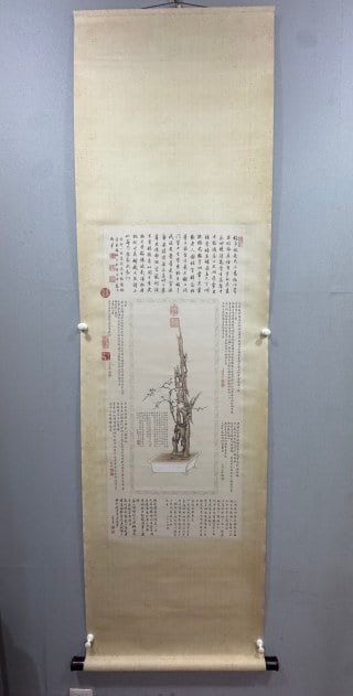 Plum blossom map in Gu Gan, Zou Yigui: For the vertical axis of the paper, the whole width is wide. The center picture draws a pot of ancient wooden bonsai, and the old trees in the pot are vigorous. Around the center of the main