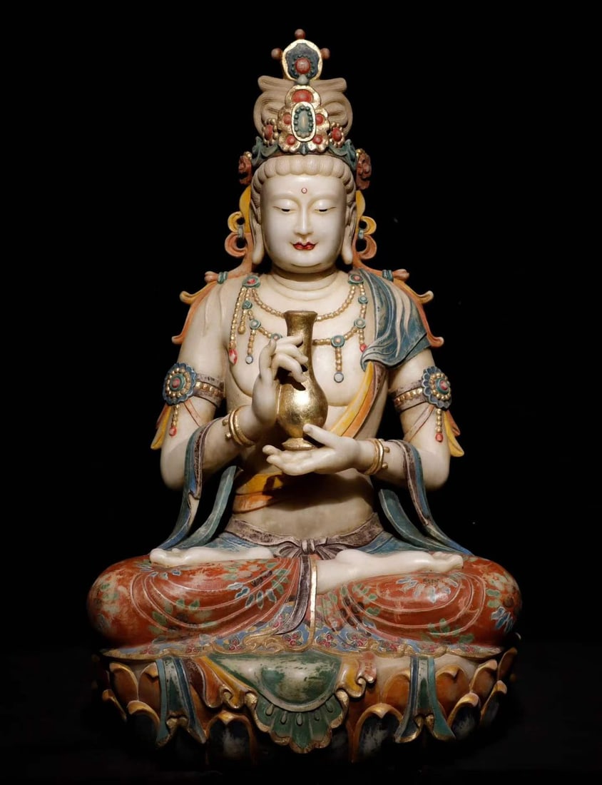 White marble painted Guanyin: Stone statue, Guanyin sitting on the lotus pedestal, wearing a crown, round face. Holding a gold-plated bottle in both hands. The whole body is decorated with wreaths and armbands, and the robes are
