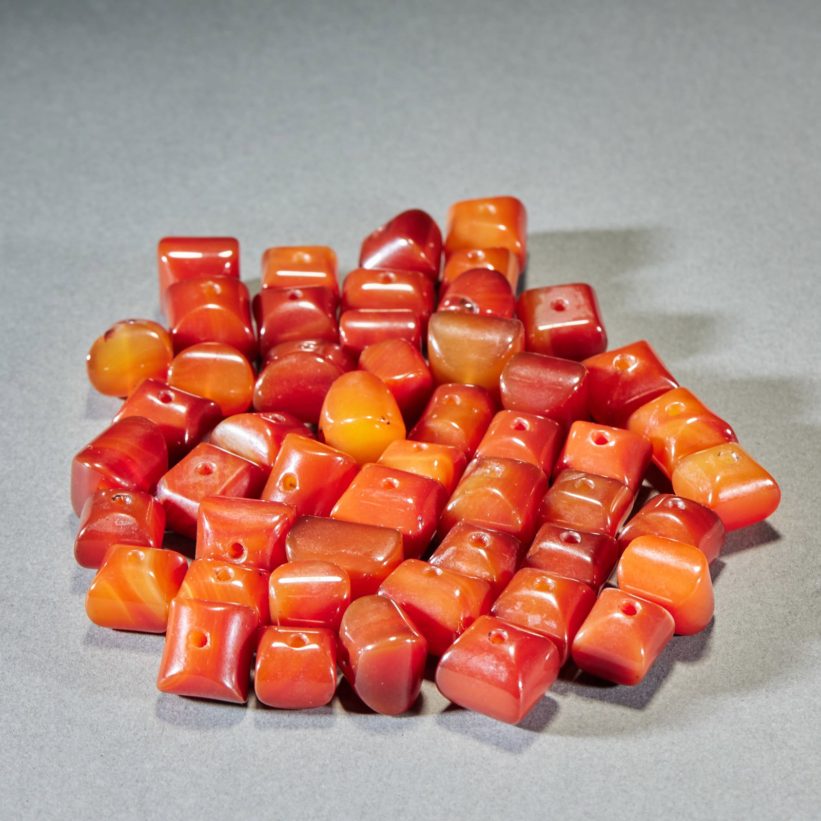 50 agate square beads: A number of agate beads are orange, vermilion and orange in overall tone, and the beads are square with rounded corners, and each bead is drilled with a through hole in the center. Natural agate