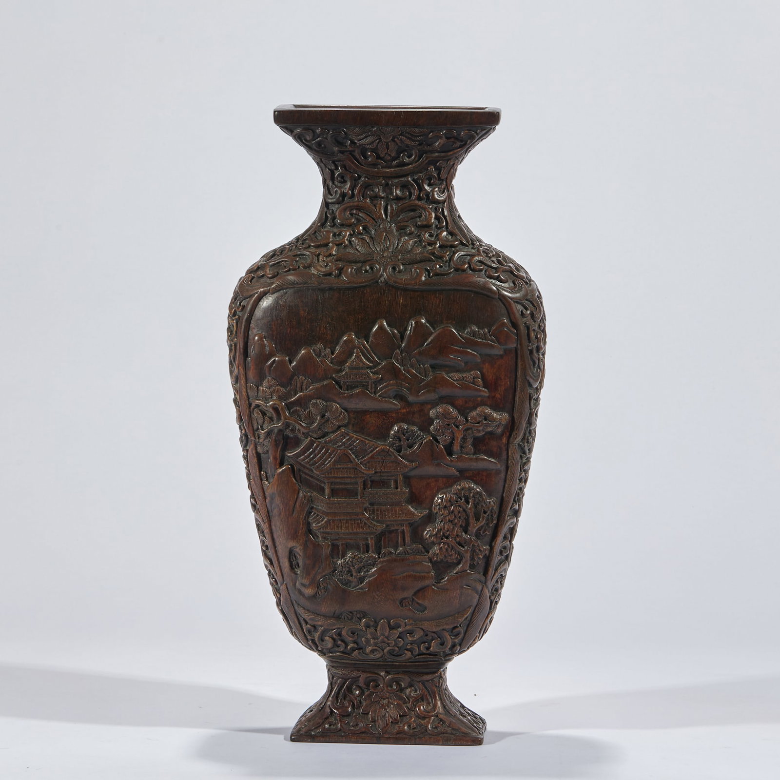 Relief landscape pavilion thymelaeaceae bottle viewing: Thymelaeaceae is carved from the whole material, with a square mouth, a neck and a square circle. The neck and sides of the bottle are full of flowers with tangled branches. The two sides of the