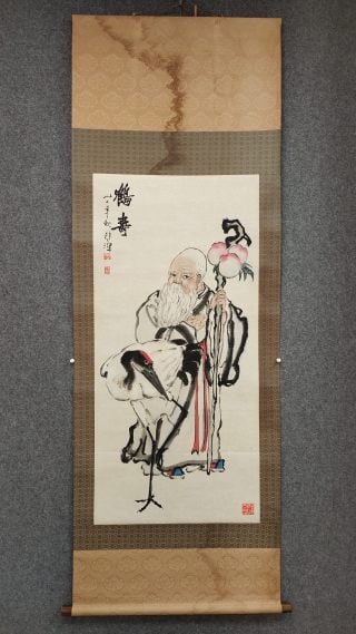 Xu Beihong He Shou Tu: The paper is colored with vertical axis and originally mounted. The picture shows an old man with a long white beard, holding a peach cane and standing beside him with a red-crowned crane. The inscrip