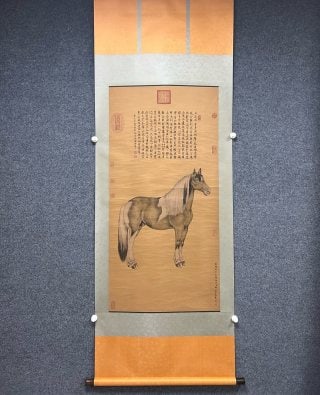 Lang Shining BMW map silk edition: Silk vertical shaft, ancient mounting. In the upper part of the picture, a large section of regular script inscription is written, and a standing horse is drawn below, which is strong and strong.