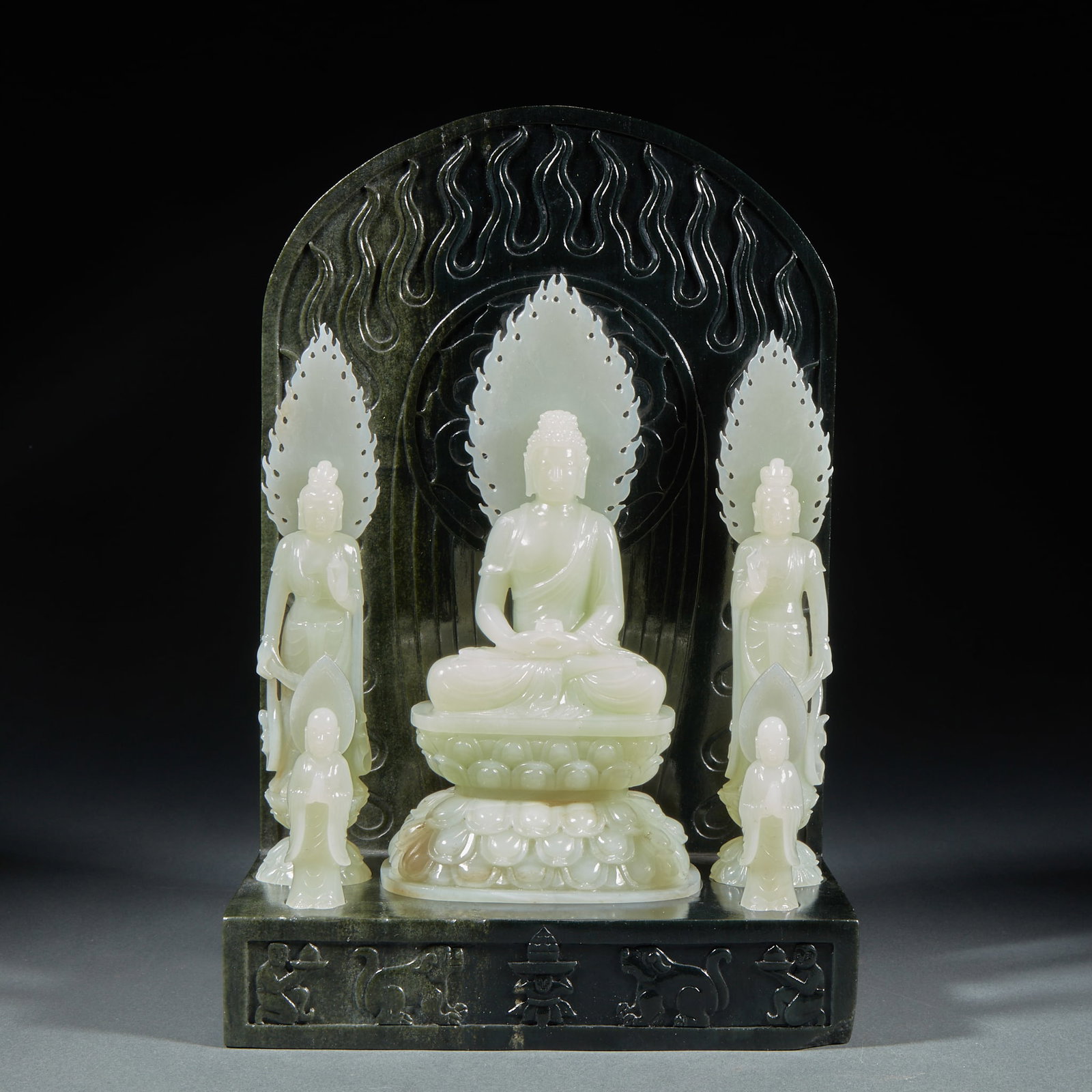 Statues of Hetian Jade's Western Three Saints and Two Disciples in Qing Dynasty: The main Buddha, the threatening Bodhisattva and the two disciples are all Hetian Baiyu. The main Buddha sits on a white jade lotus platform with a white jade flame pattern behind him. On both sides,